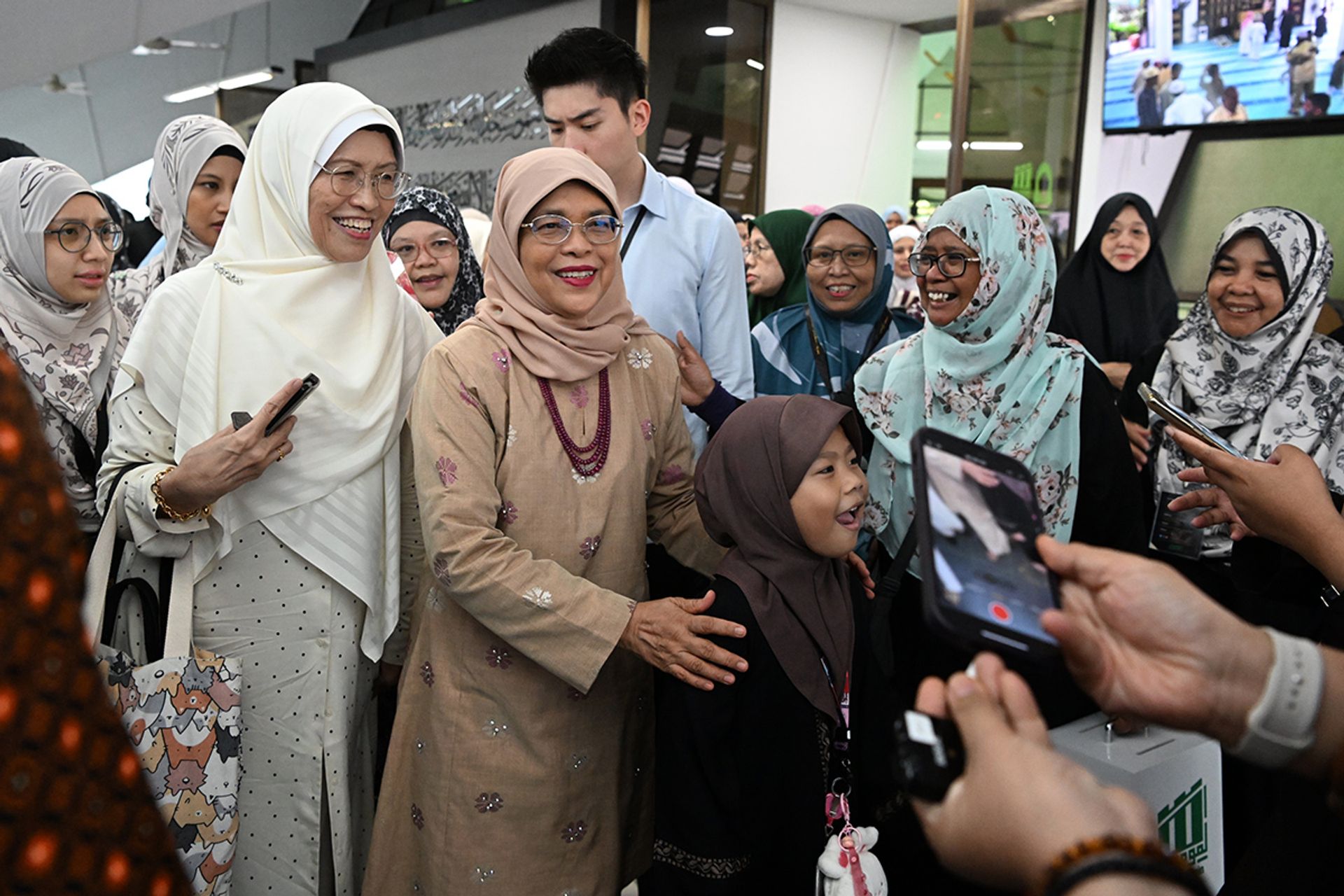 President Halimah greeting congregants at Masjid Al-Mukminin on June 29, 2023. ST PHOTO: CHONG JUN LIANG