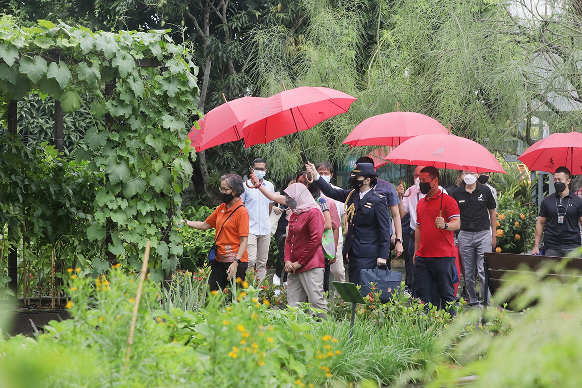 President Halimah walking through Active Garden, a new attraction at Gardens by the Bay that she officially opened on April 2, 2022. The 1ha space comprises a community garden, two lawns for recreation, fitness equipment for people of various ages, a room for nature-related workshops, and a pet-friendly cafe. ST PHOTO: KELVIN CHNG