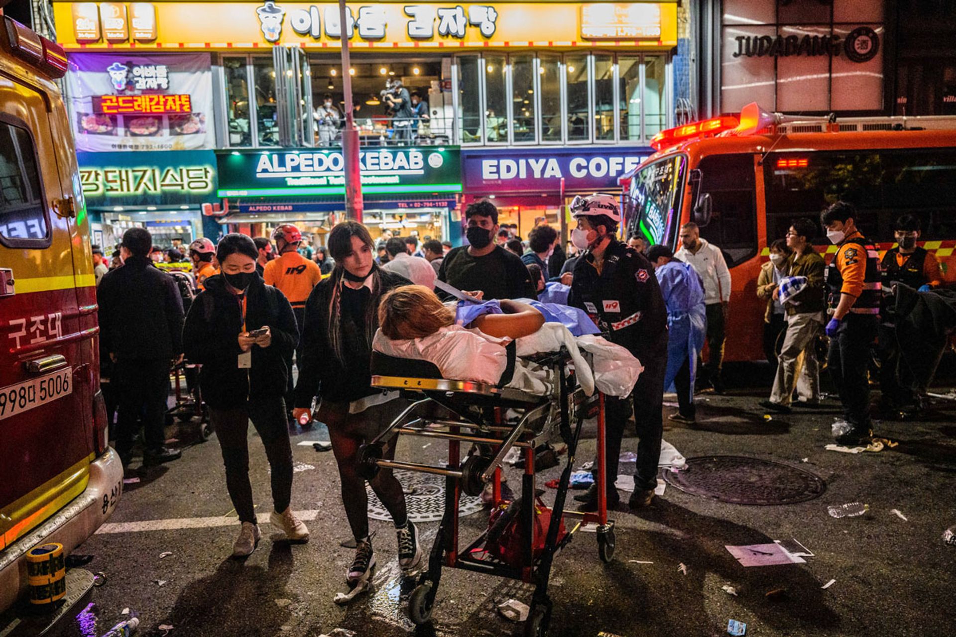 First responders helping an injured person on a stretcher in the immediate aftermath of the Oct 29 disaster in an Itaewon alleyway. PHOTO: AFP