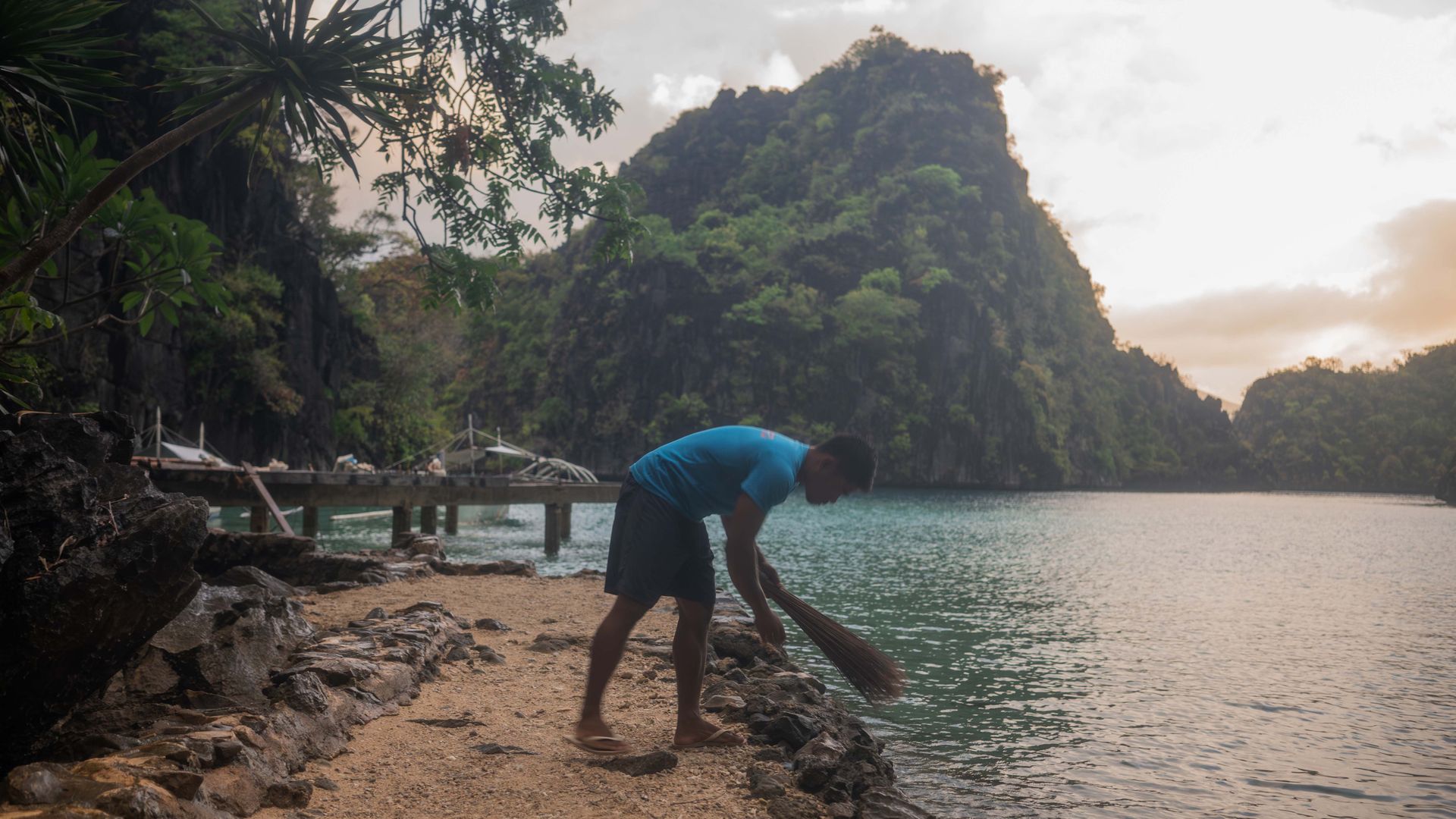 Mr Aguilar beginning his day’s work on the beach that tourists pass through to get to the lake. PHOTO: VINA SALAZAR