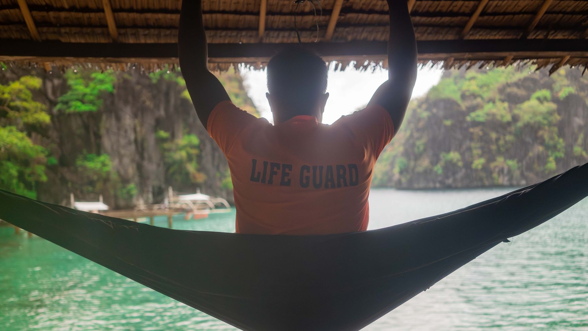 Mr Aguilar, watching over the waters from a hammock while on lifeguard duty, is happy that the tourists have returned. PHOTO: VINA SALAZAR