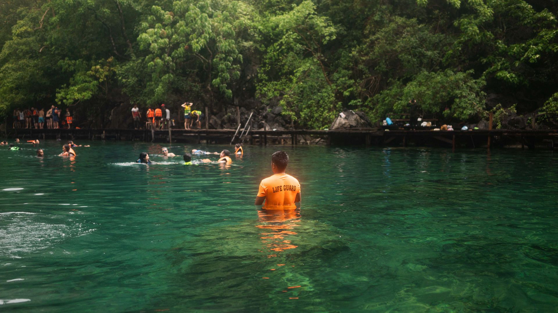 Mr Aguilar does not just watch over the tourists frolicking in the waters; he also picks up after them. PHOTO: VINA SALAZAR