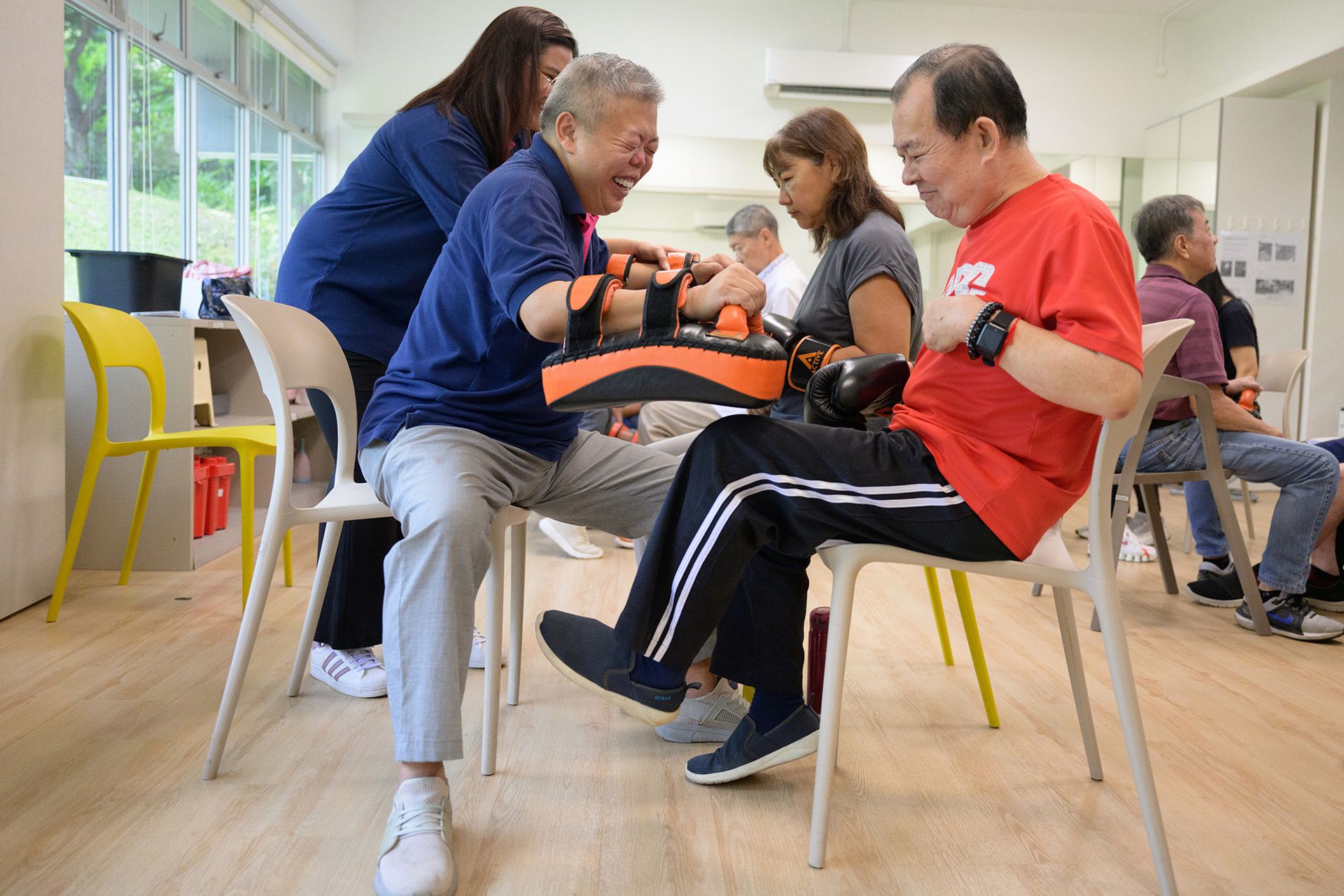 Mr Liew Teck Chye, 70, kicking a boxing pad held by Mr Patrick Chiam, 50, who helps to plan and execute activities like modified kickboxing, to help fellow stroke survivors with their rehabilitation at the Stroke Support Station.