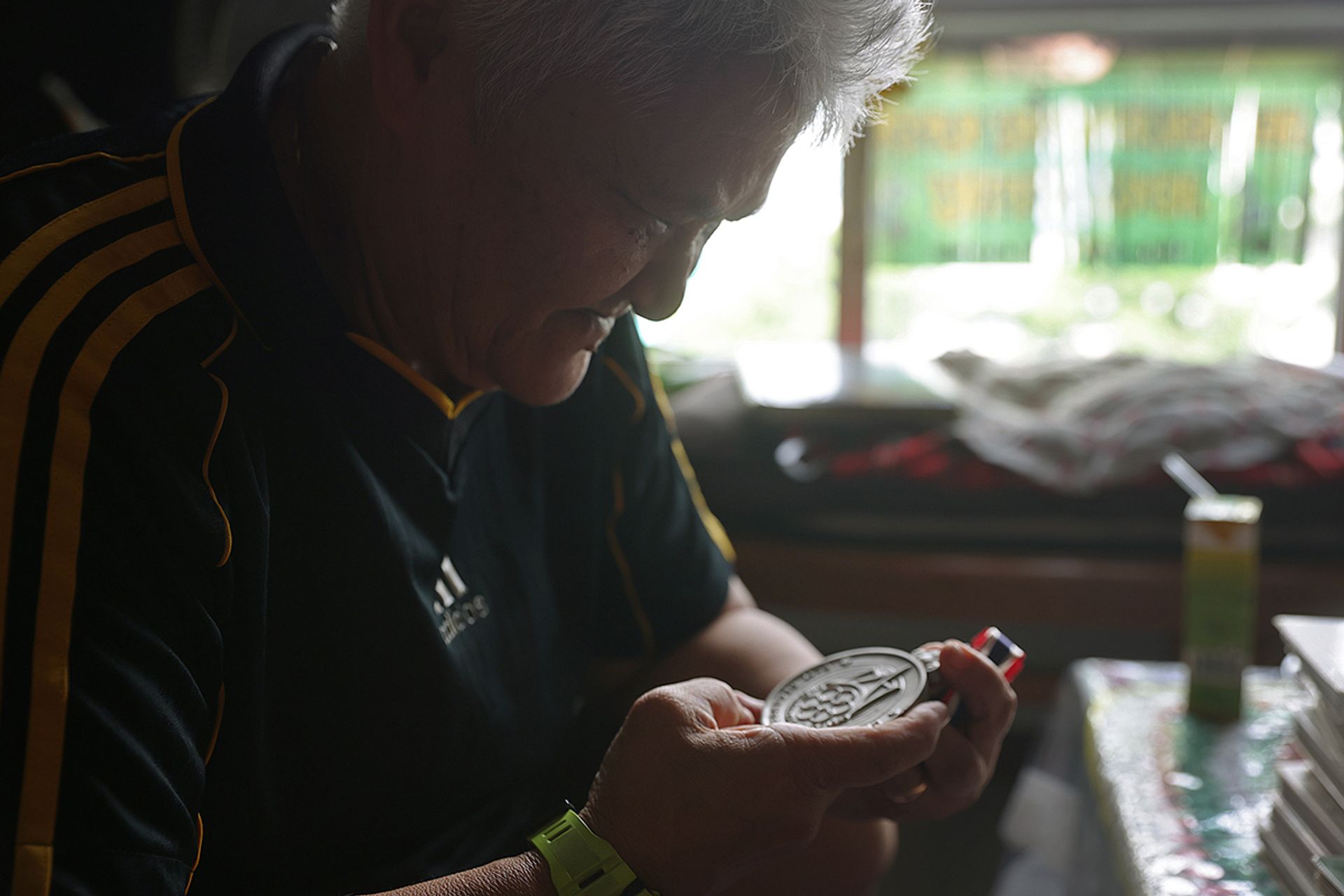 Madam Maimun Wahab looking at her 1985 SEA Games silver medal, which she considers the highlight of her career even though the Singapore team lost to Thailand in the final.