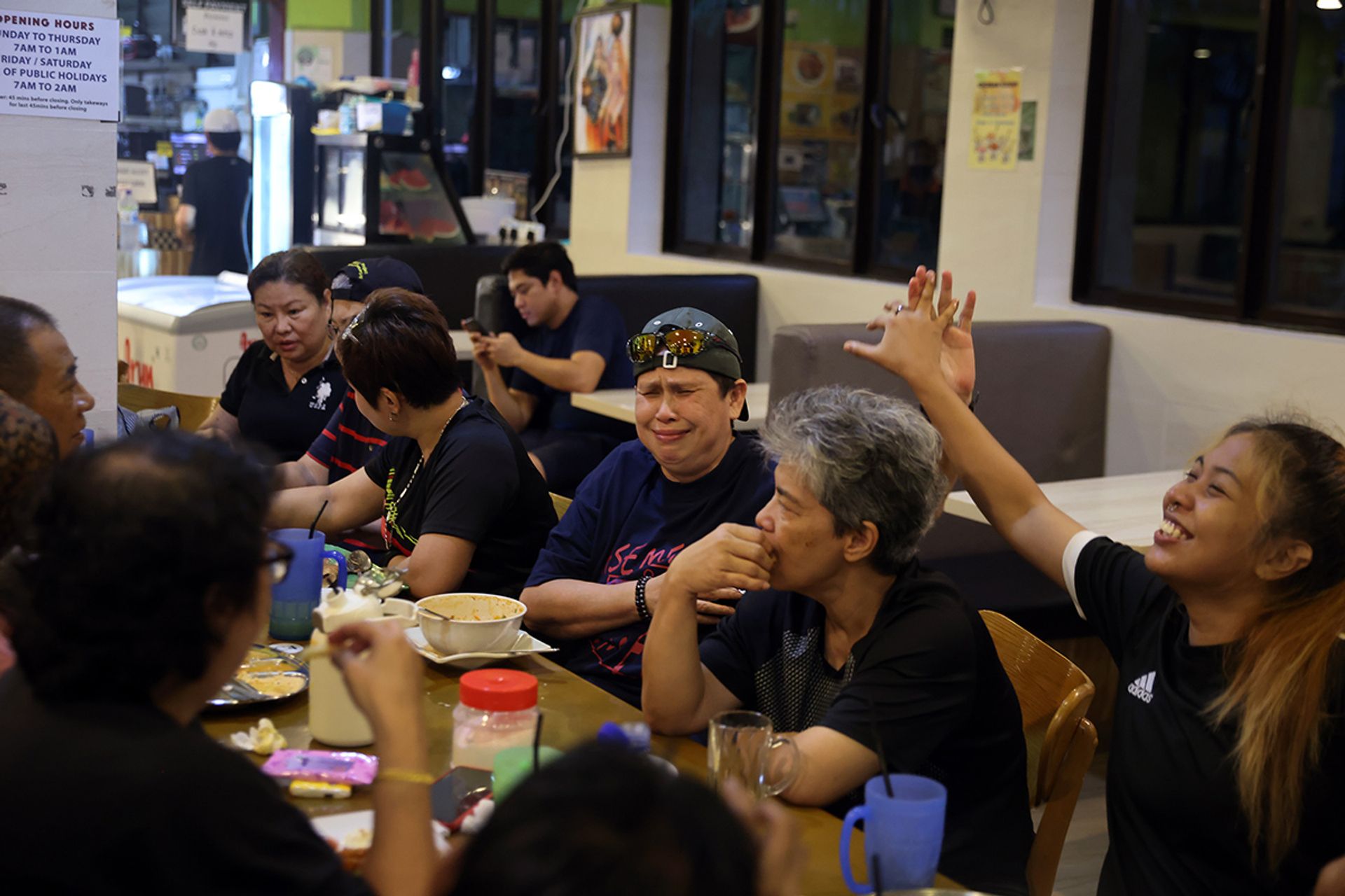 Ms Nur Hanis Amira (right), 22, sharing a joke with Madam Rabiah Mat (wearing a cap), 60, during one of the team’s post-training meals.