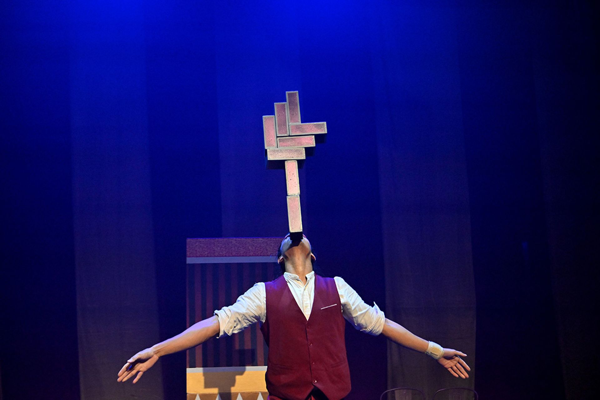 “Nachos” Nyan Lin Cho rehearsing his juggling act, which incorporates rectangular props that resemble cigar boxes.