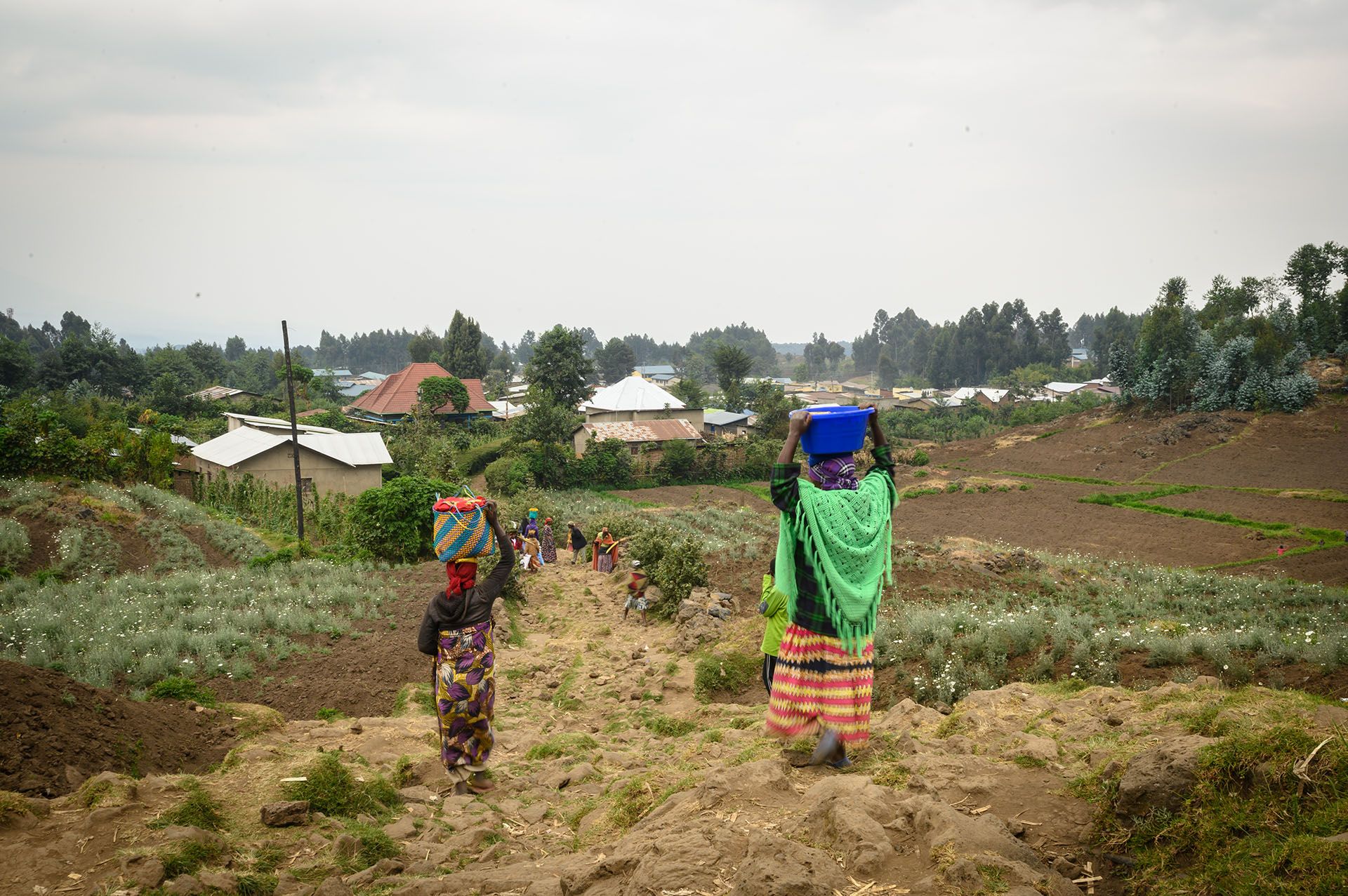 Farmers tread through the hilly fields every day, walking for about two hours to get to the village centre where amenities such as the market and clinic are located.