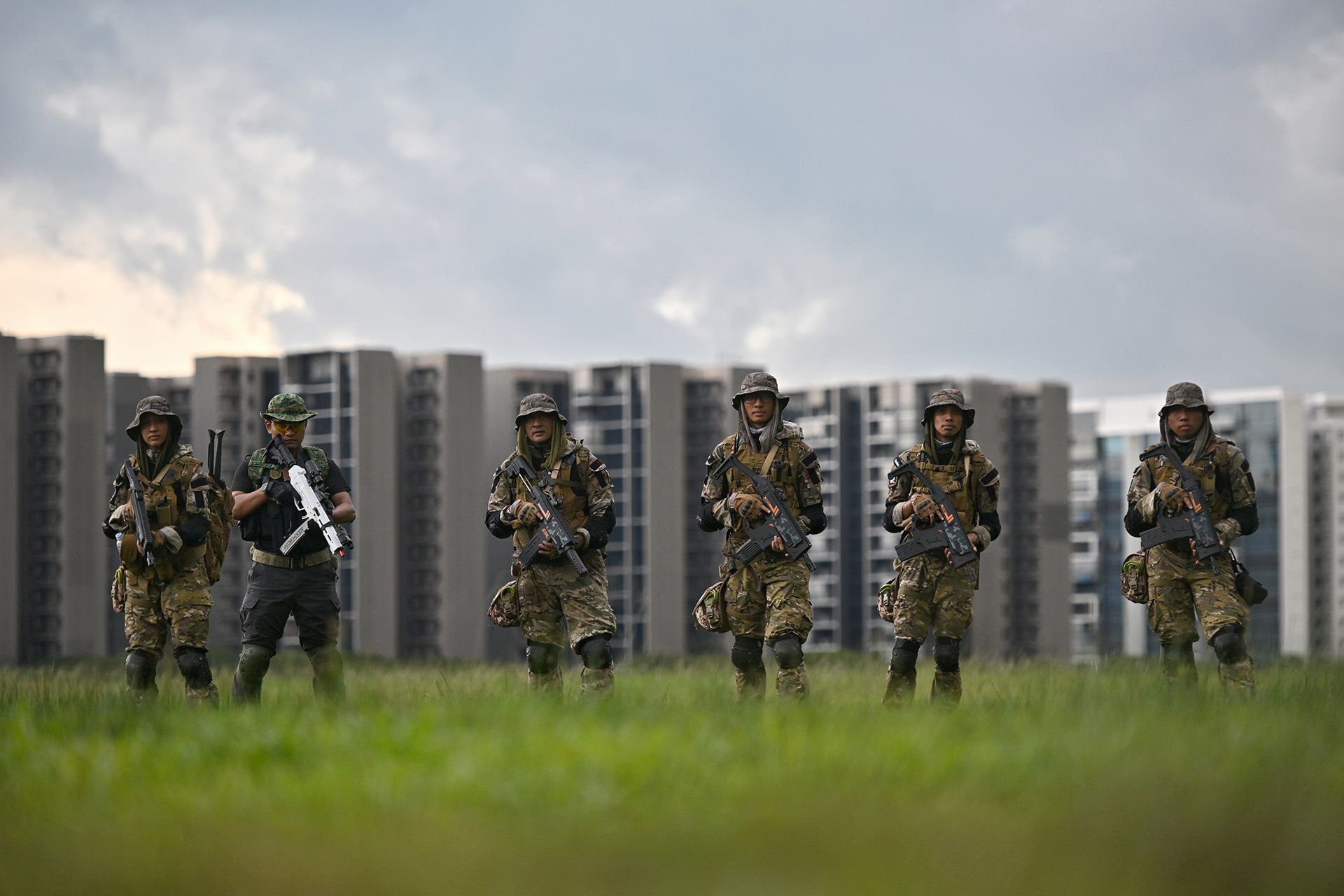 (From left) Siti Hadijah, Mr Muhd Al-Syafiq, an “apprentice” who trains with the family occasionally, Mr Mohd Munir, Mr Ahmad Abdullah, Mr Mohd Wira and Mohd Afnan in a field next to Tampines Quarry.