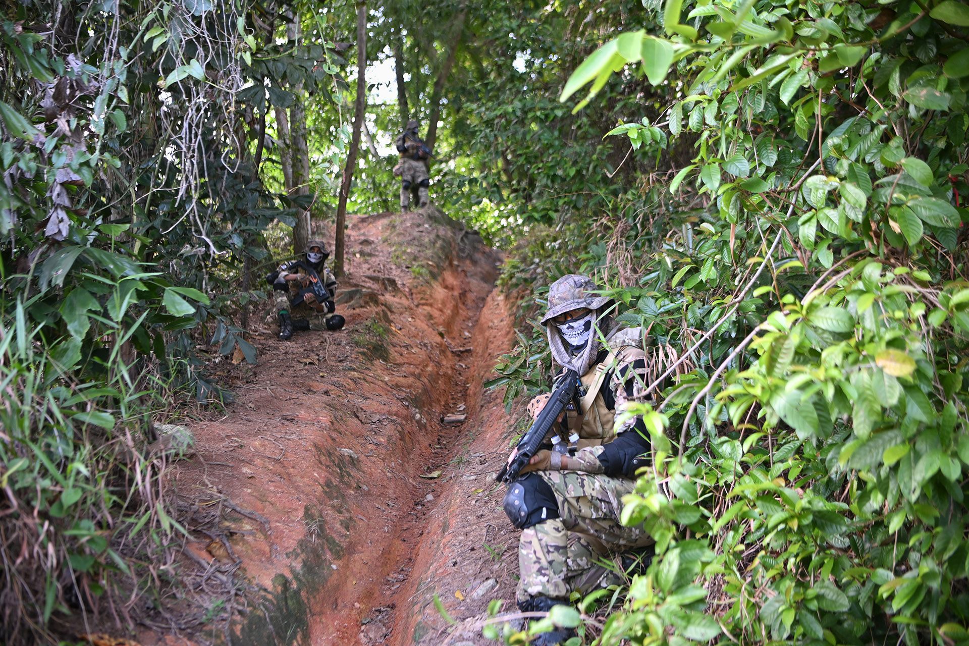 (From right) Mr Ahmad Abdullah, Mr Mohd Munir and Mr Mohd Wira standing in a column formation at Tampines Quarry, blending in perfectly with their surroundings.