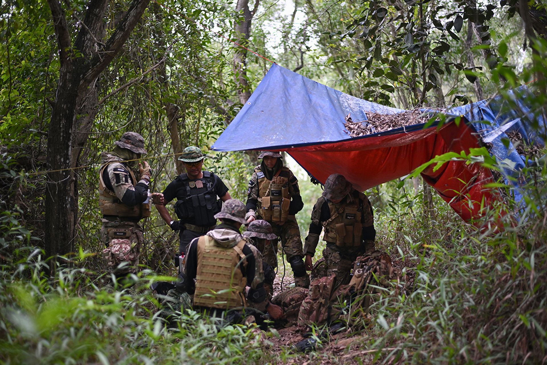 Taking a break under a makeshift tent left behind by others, the family emphasises the importance of cleaning up and being mindful not to damage surrounding vegetation.