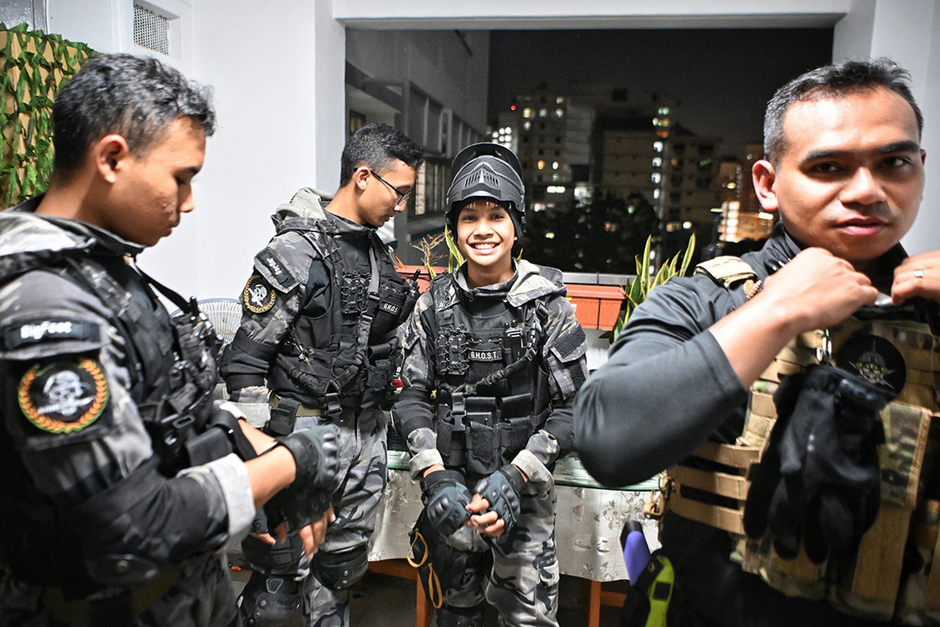 (From left) Siblings Mohd Afnan, Ahmad Abdullah and Mohd Luqman, and family friend Muhd Yasser, strategising and gearing up for a scenario-based close-quarters combat session.