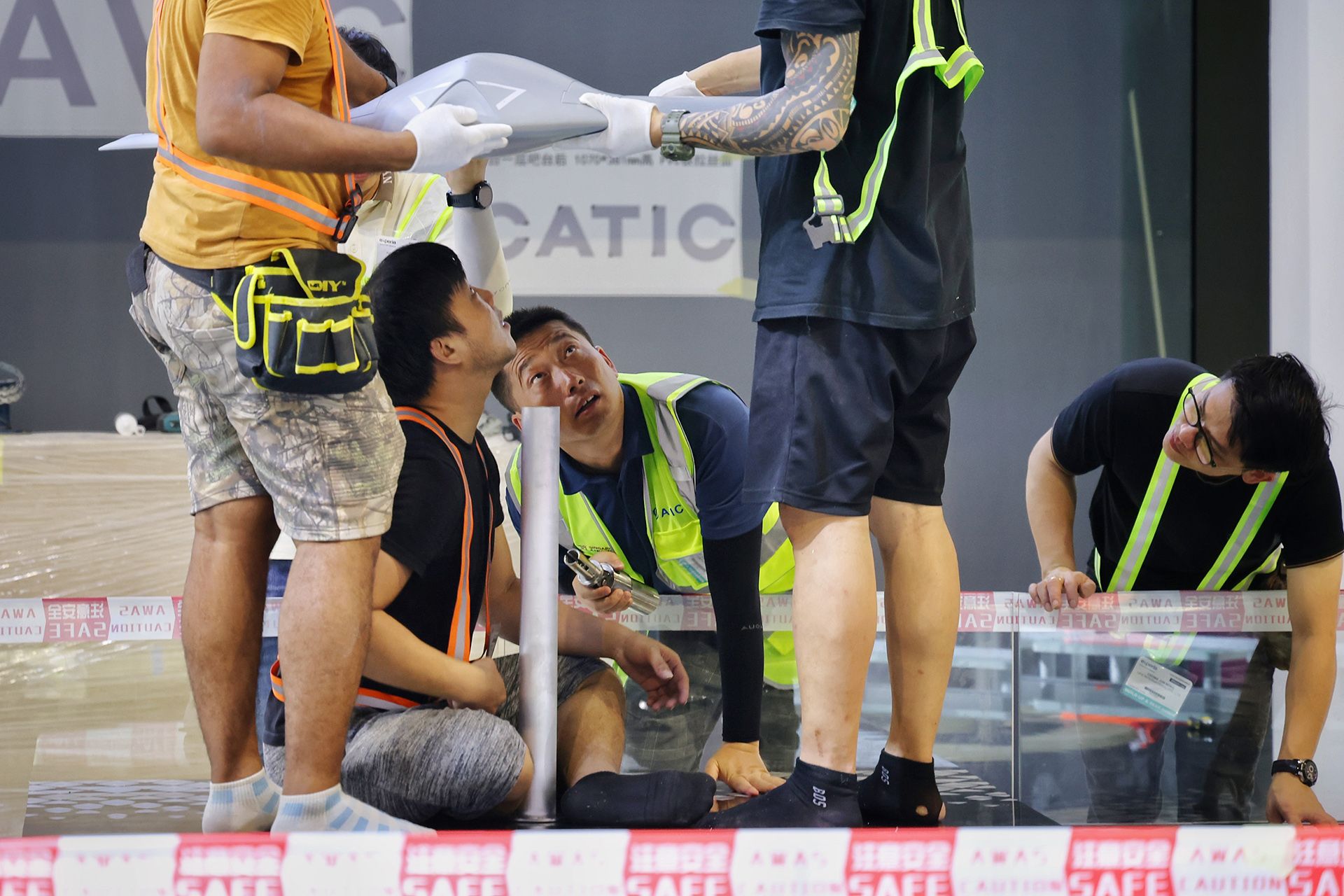Workers setting up the Aviation Industry Corporation of China booth at the Changi Exhibition Centre on Feb 15. ST PHOTO: JASON QUAH