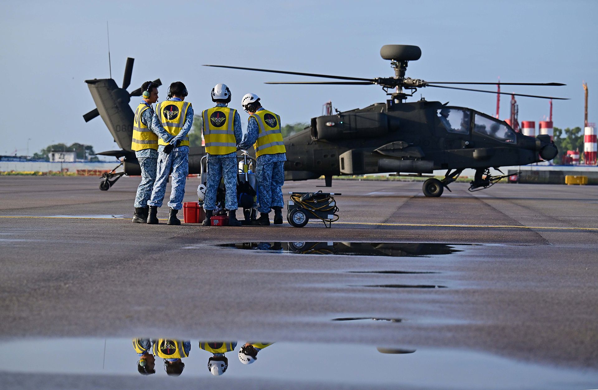 Ground crew checking the AH-64D Apache after it lands at Changi Exhibition Centre on Feb 14. ST PHOTO: DESMOND FOO