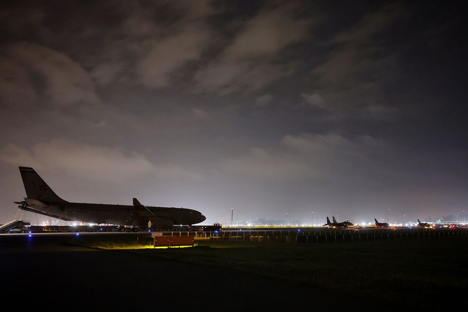 RSAF personnel carrying out night towing of the (from left) an A330 MRTT, an F-15SG, a F-16D and a F-16D+ from Changi Air Base (East) to Changi Exhibition Centre on Feb 13. ST PHOTO: KEVIN LIM