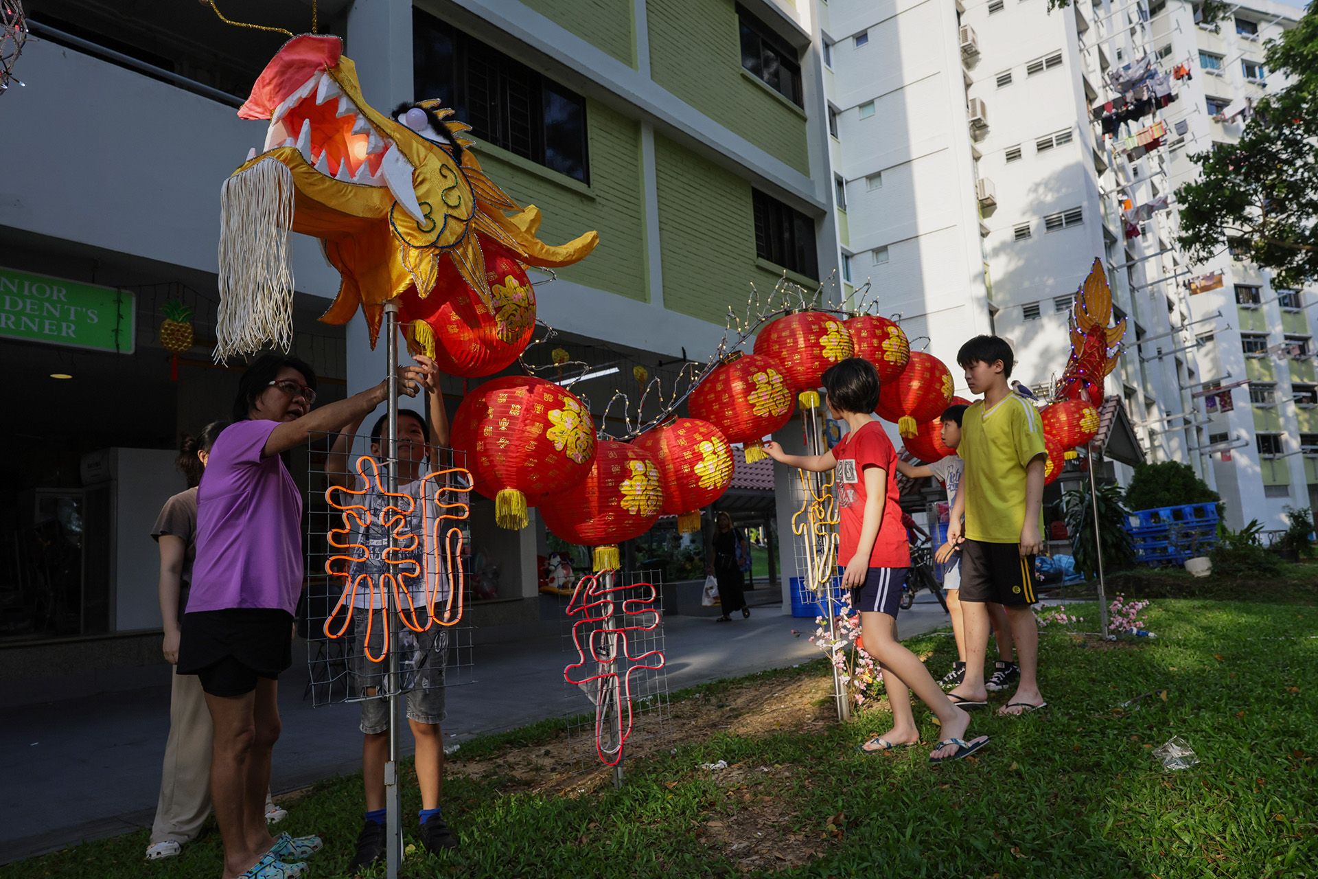 Fashioned from repurposed lanterns, Chinese New Year attire, lightbulbs, bamboo and Styrofoam boxes, the dragon embodies the community spirit, and will add a vibrant touch to Chinese New Year festivities in the neighbourhood until the end of February. ST PHOTO: GIN TAY