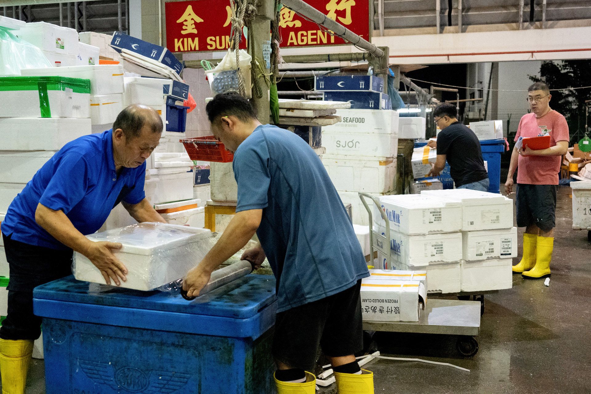 Mr Daniel Pe watching as his workers packaged orders before delivering them to various clients around Singapore.