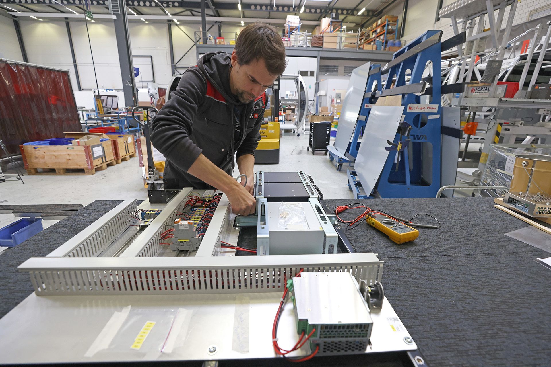 E-services supervisor Samuel Egloff checking the electrical board that is to be fixed onto the cabin.