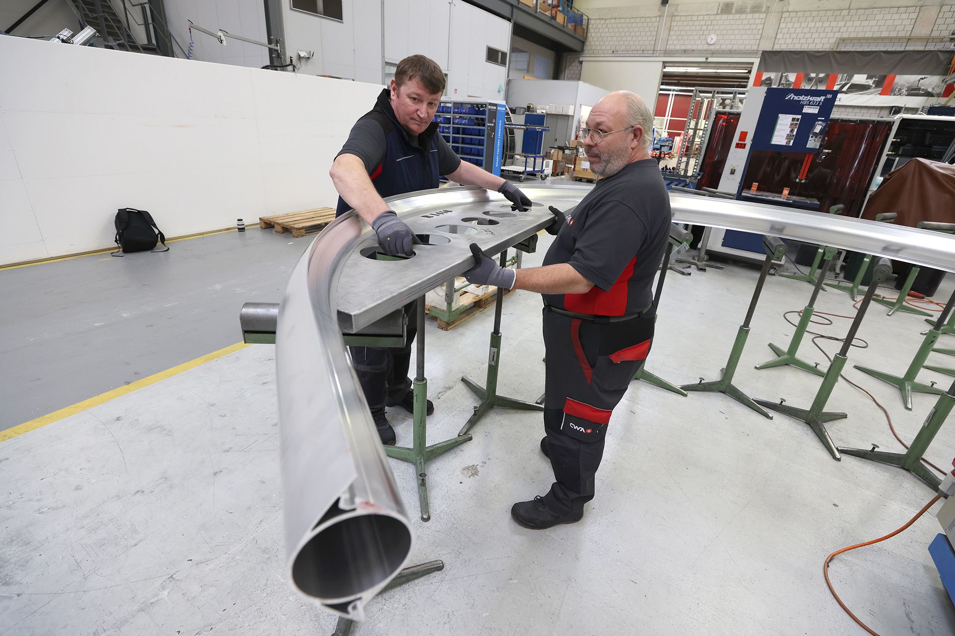 CWA technicians Oliver Zivkovic (left) and Pascal Rodriguez, both bending specialists, using a stencil to measure the arch of an aluminium cabin column on Nov 8, 2023. Precise conformity to specifications guarantees structural integrity and safety.
