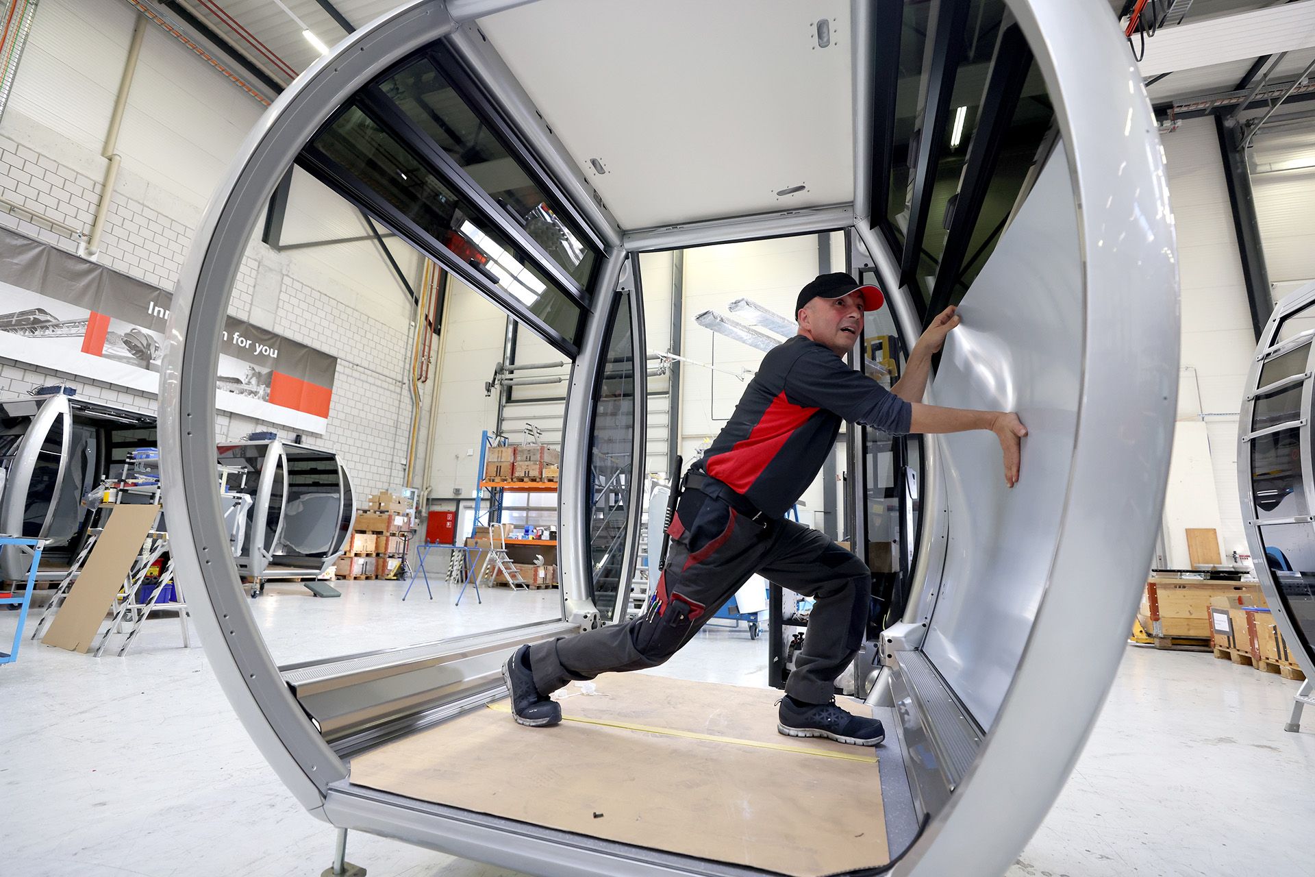 CWA technician Marco Sanfilippo installing a polycarbonate window onto a cabin. These windows are shock-resistant and UV-proof.