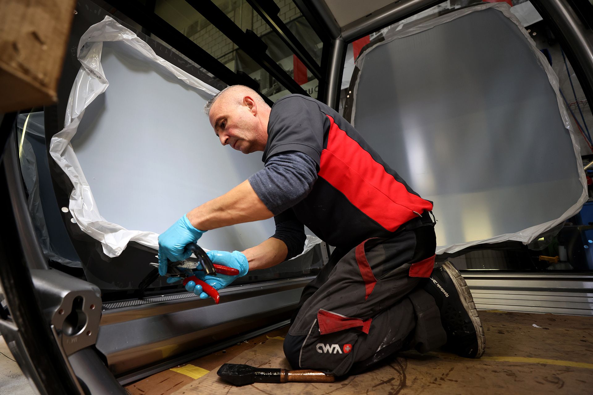 CWA technician Marco Sanfilippo sealing the rubber lining to be mounted onto the window.