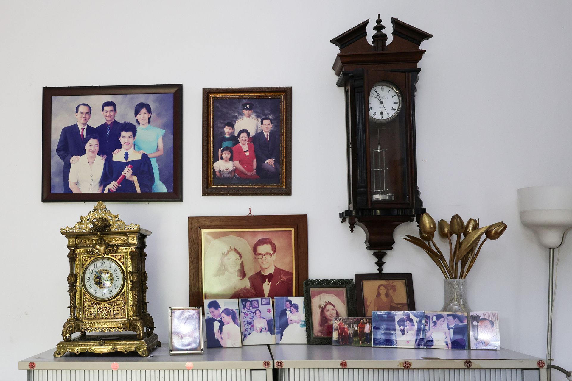 Seen among family portraits, is a French brass clock (left) by A.D. Mougin, dating back to around 1880, and a verge escapement torsion pendulum wall clock (right) made by Gustav Becker for Anton Harder in 1881.