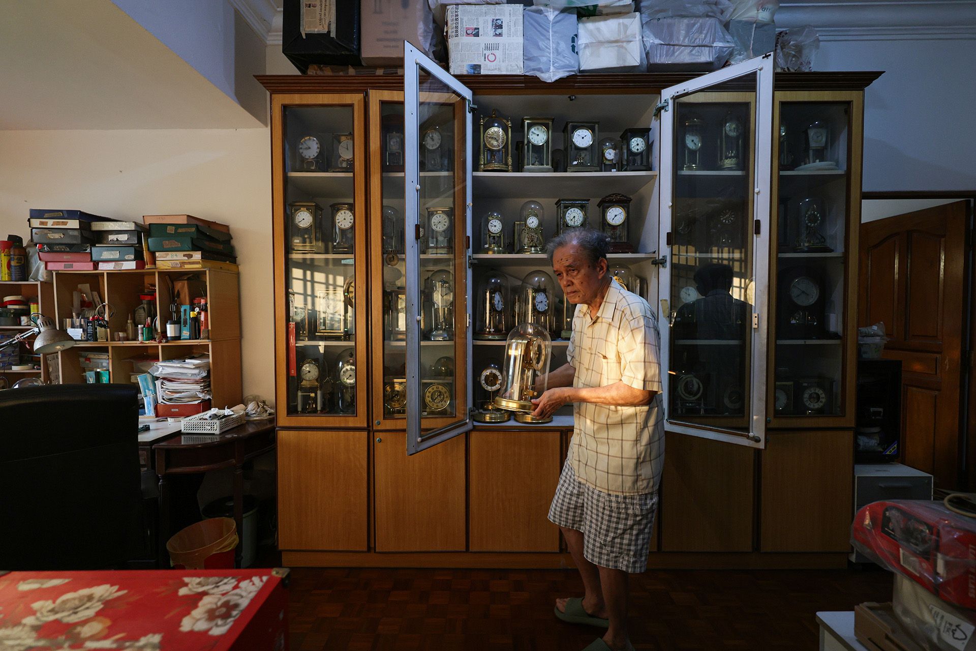 Mr Mun holding one of his vintage clocks. This Atmos clock was made to commemorate the 150th anniversary of Jaeger-LeCoultre in a limited-edition run in 1983.