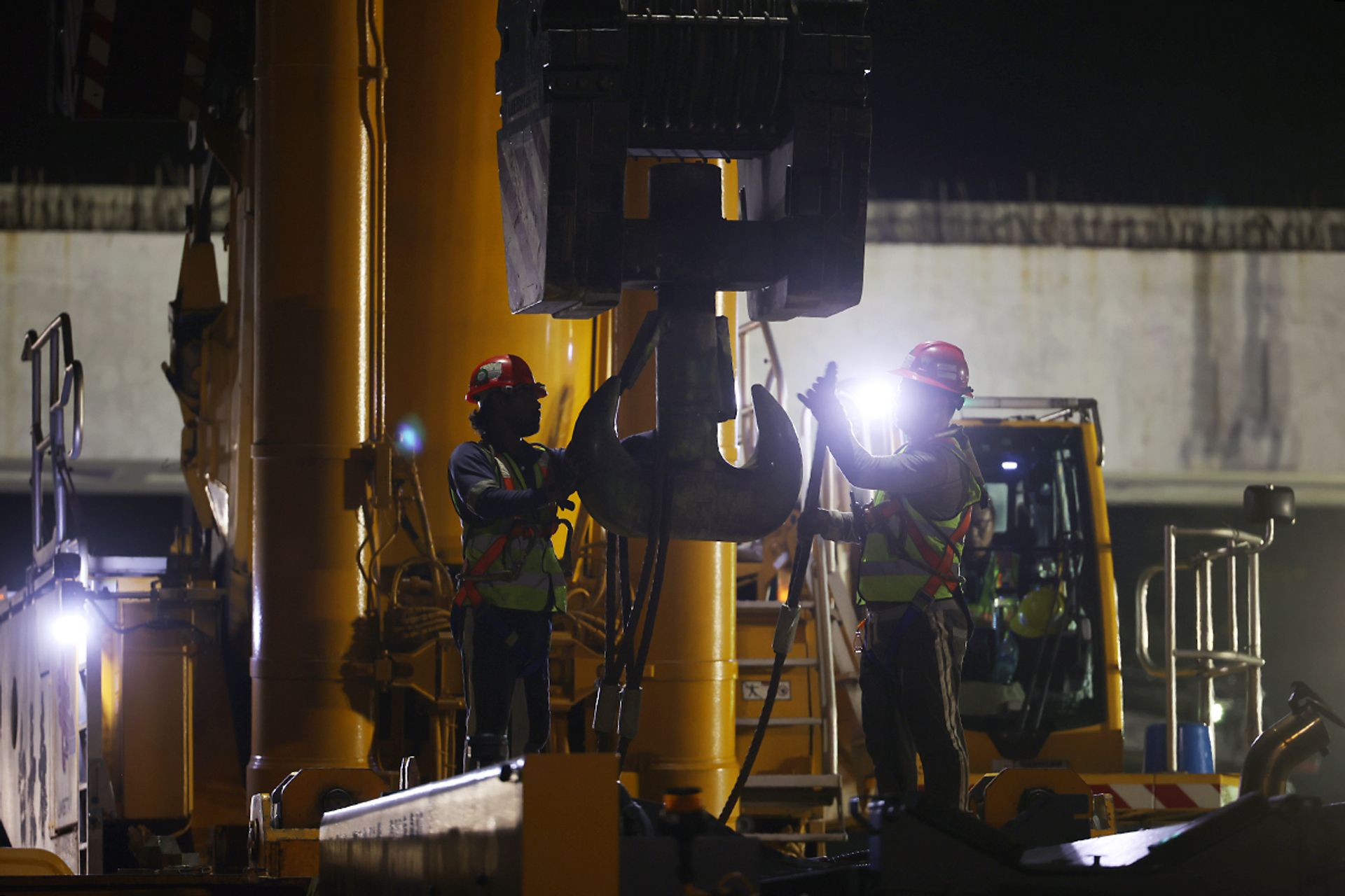 Workers setting up a crane.