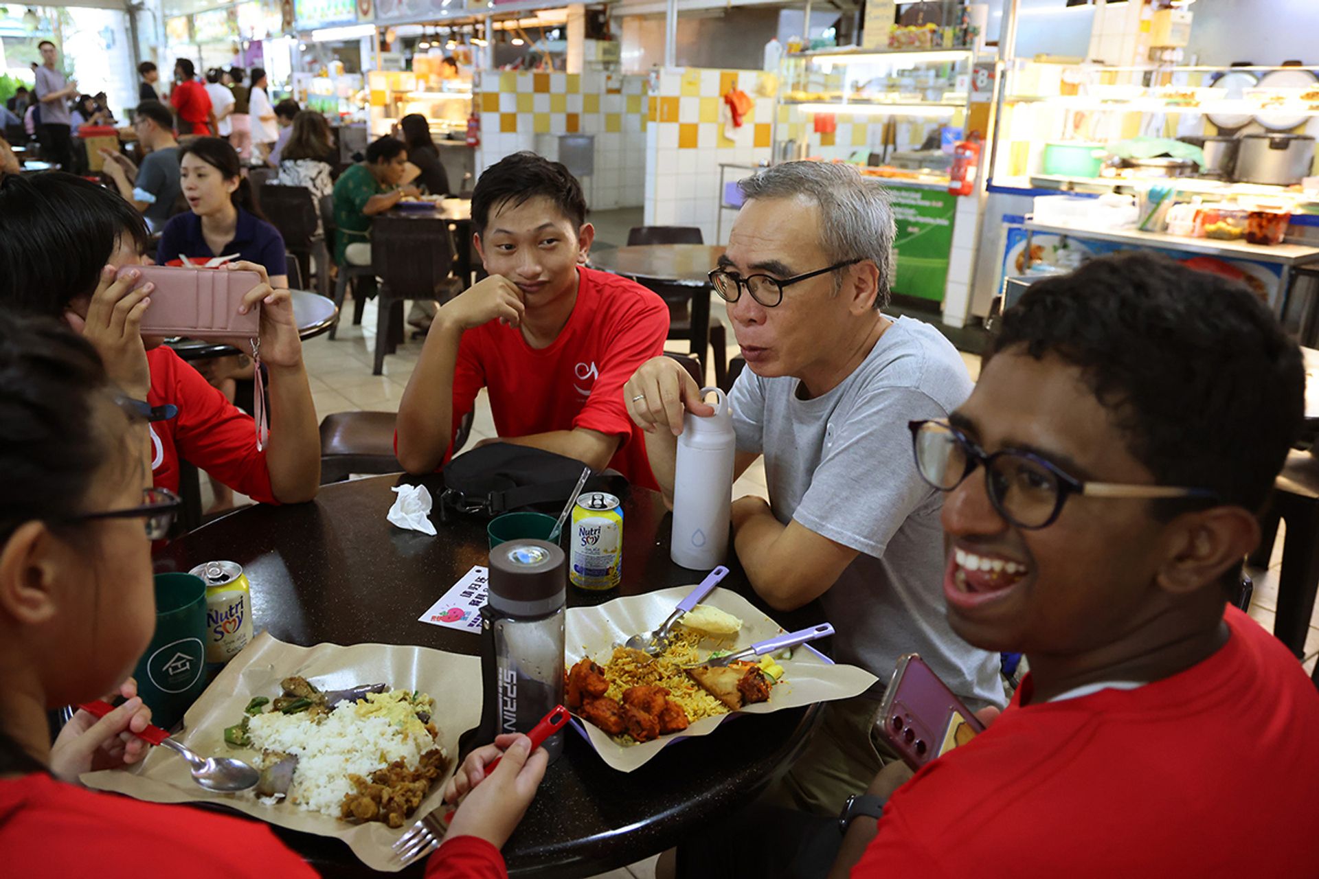 Mr Vincent Law, 60 (in grey), a consultant counsellor at Grace Mission, having lunch with (from second left) Ms Alethea Lew, Mr Raffles Ling and Mr Arunkumar Ashwin, who are some of the farm’s special needs workers. Mr Law said: “I teach (our beneficiaries) how to calm themselves down when their emotions get the better of them. They need understanding and support.”