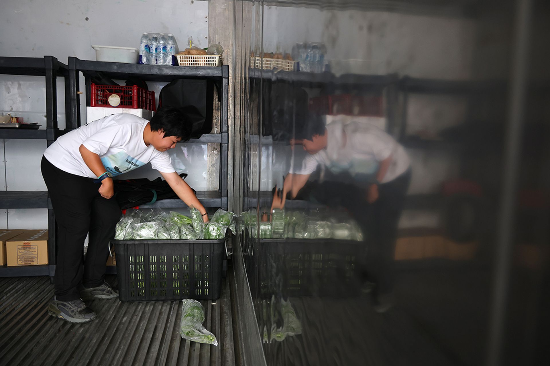 Mr Linus Chong, 21, who has cerebral palsy, storing vegetables in the freezer at the farm in March.