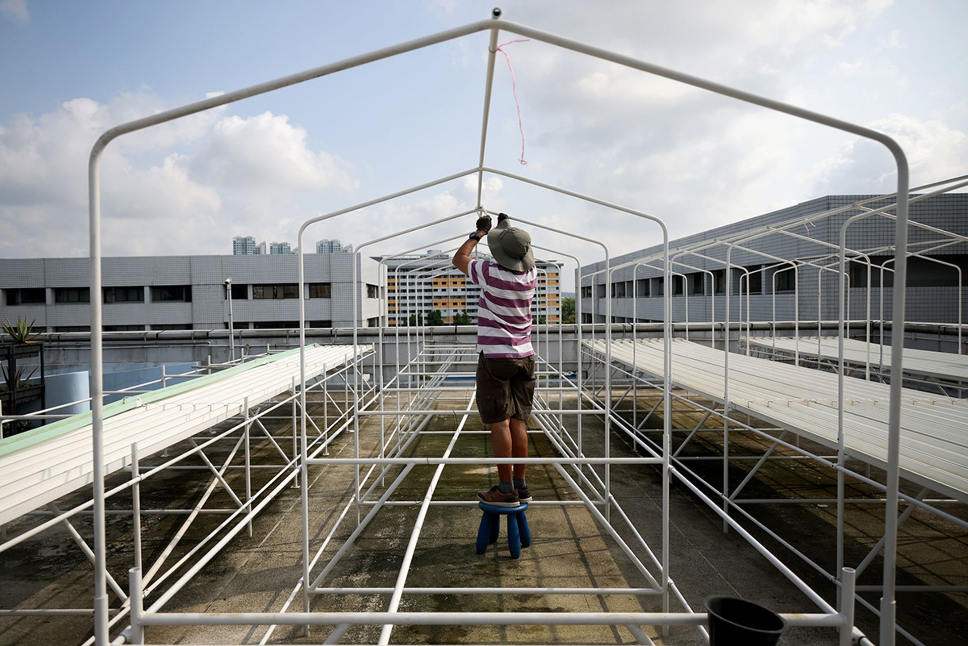 Mr Tan Boon Wang dismantling farming equipment at the rooftop premises, in preparation for the farm’s move.