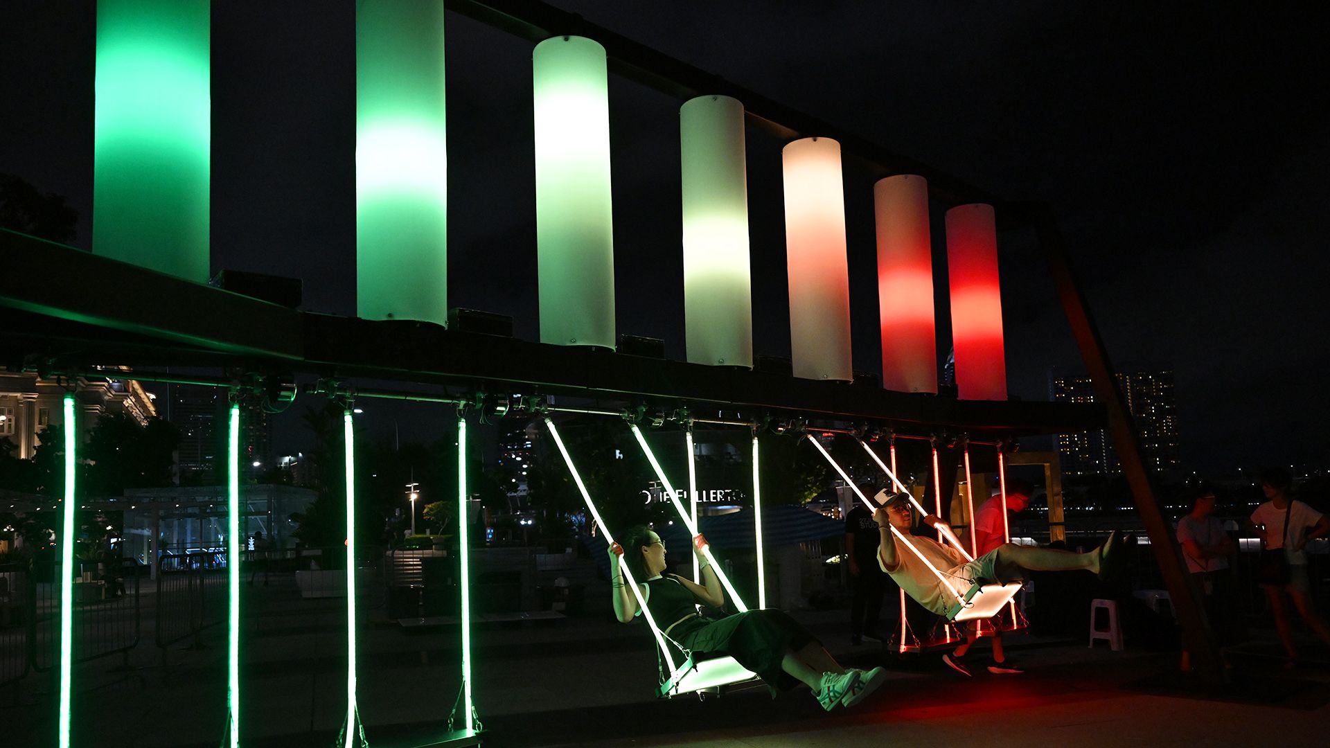 Crew members testing out the swings at Fountain Of Happiness.