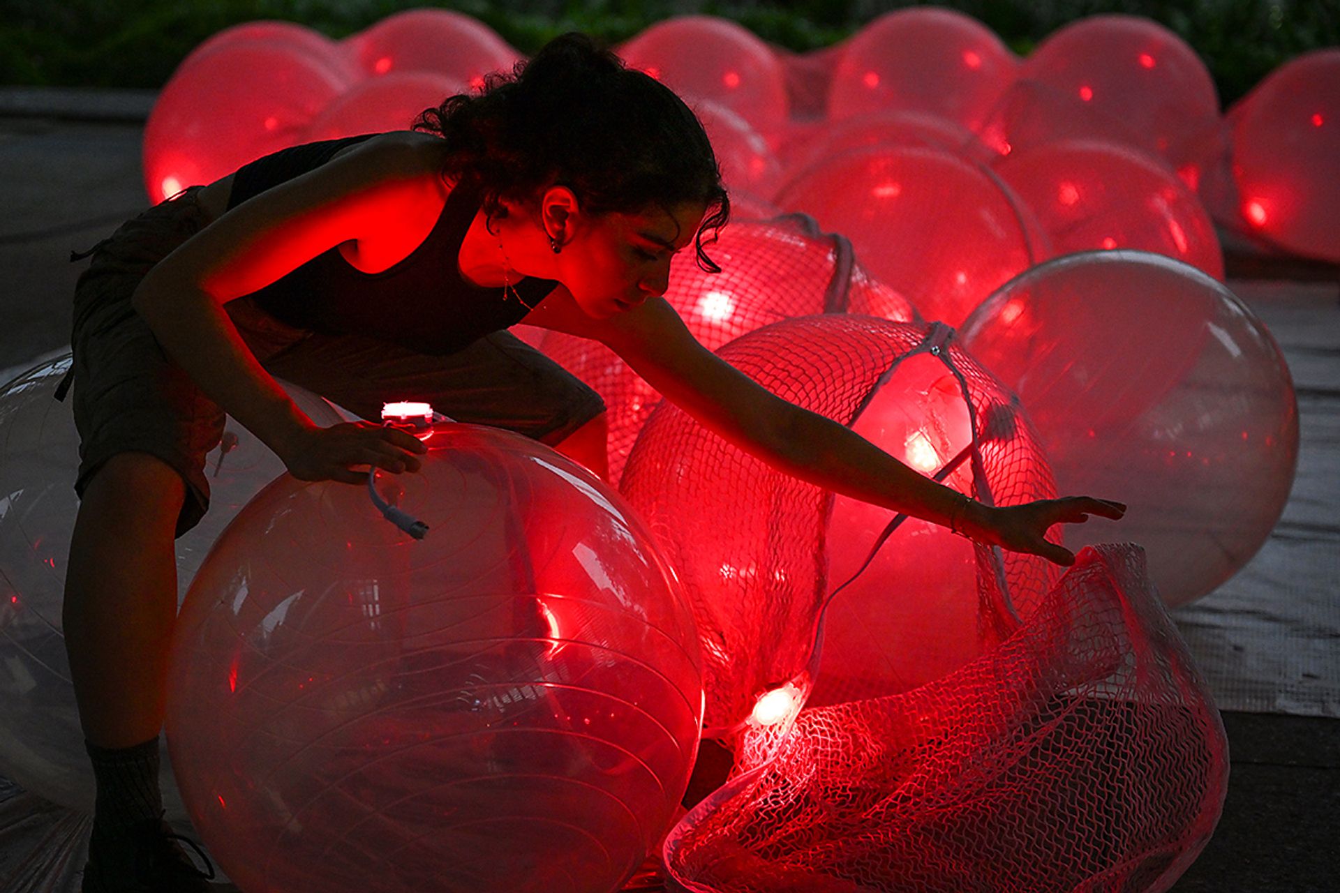 Artist Sara Ibrahim adjusting the light panels on inflatable balls that are part of Lumi, at South Beach, on May 25.