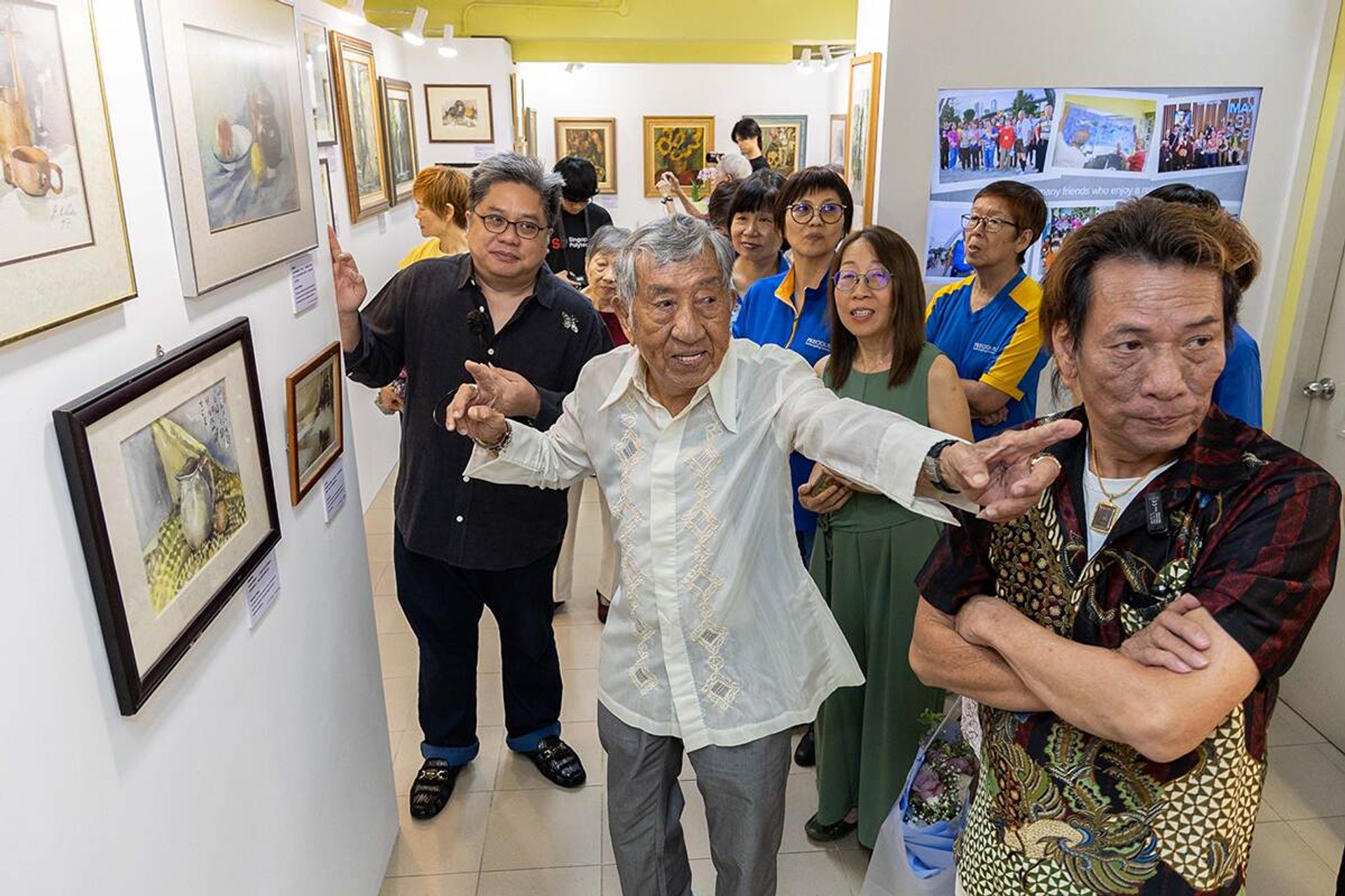 The artist giving visitors a tour of the exhibition, which has a total of 46 works of art.