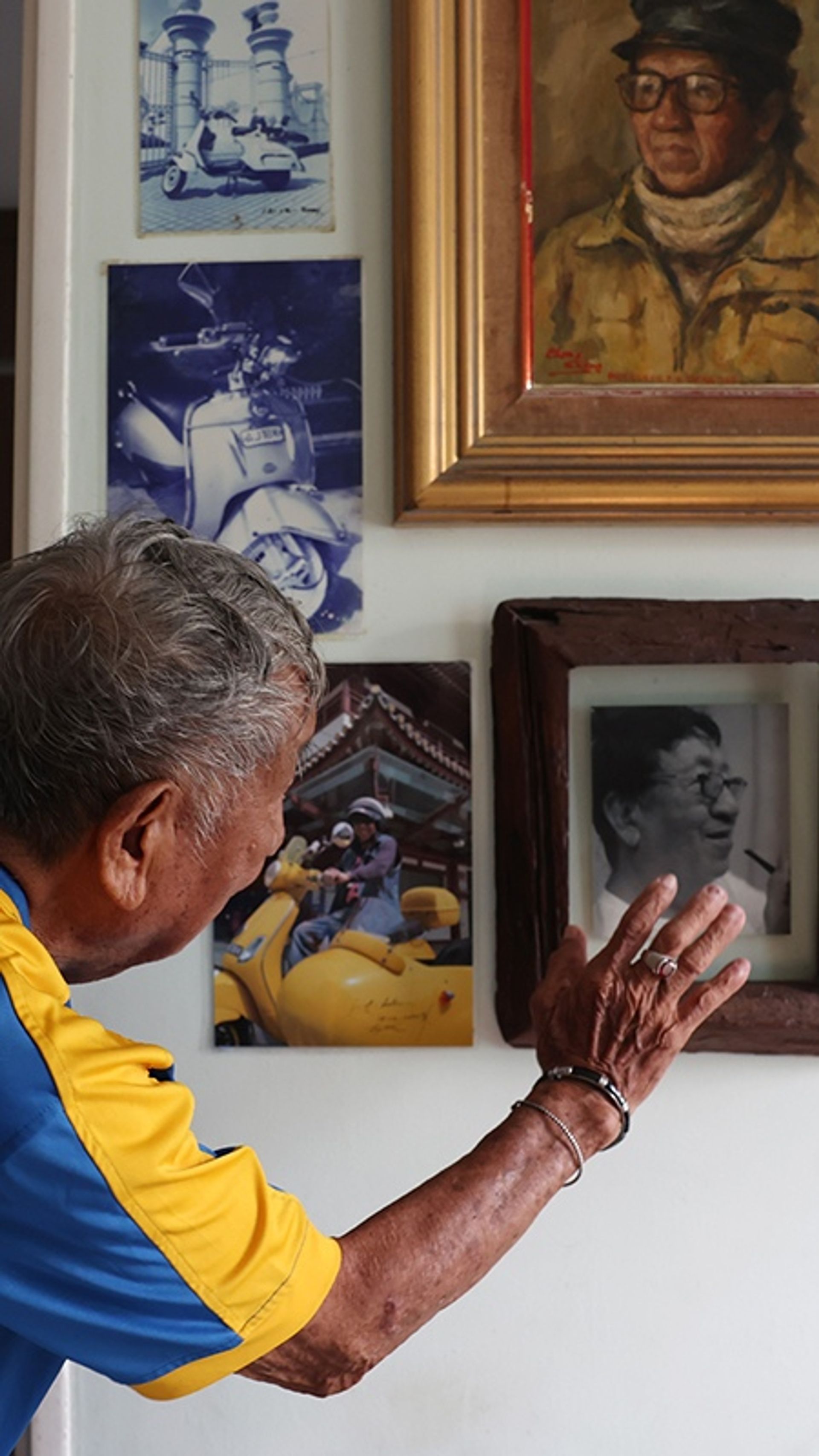 Old photos of Mr Loke hanging on a wall in his home in Punggol Emerald.