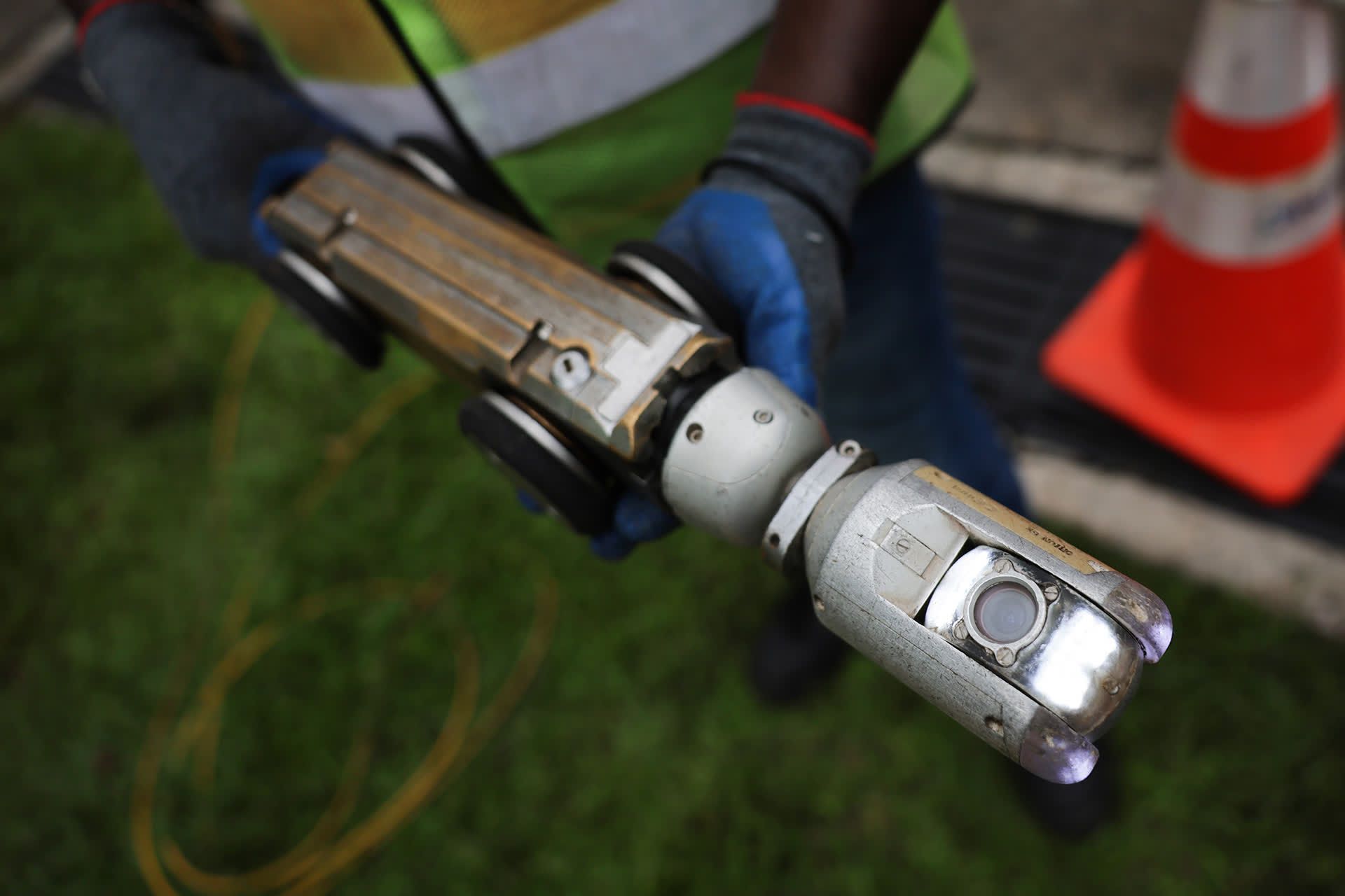 Remote-controlled robotic CCTV cameras are lowered into the sewer through a manhole and operated by technicians on the ground level.