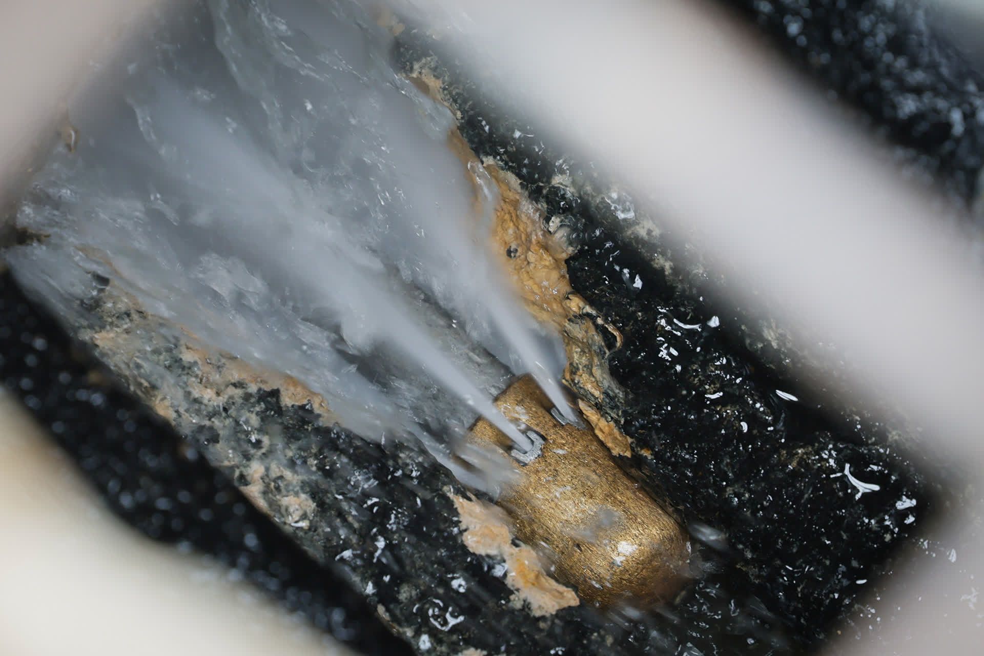 A high-pressure water jet is used to dislodge hardened grease formed over time when food waste such as cooking oil and gravy is poured down kitchen sinks.