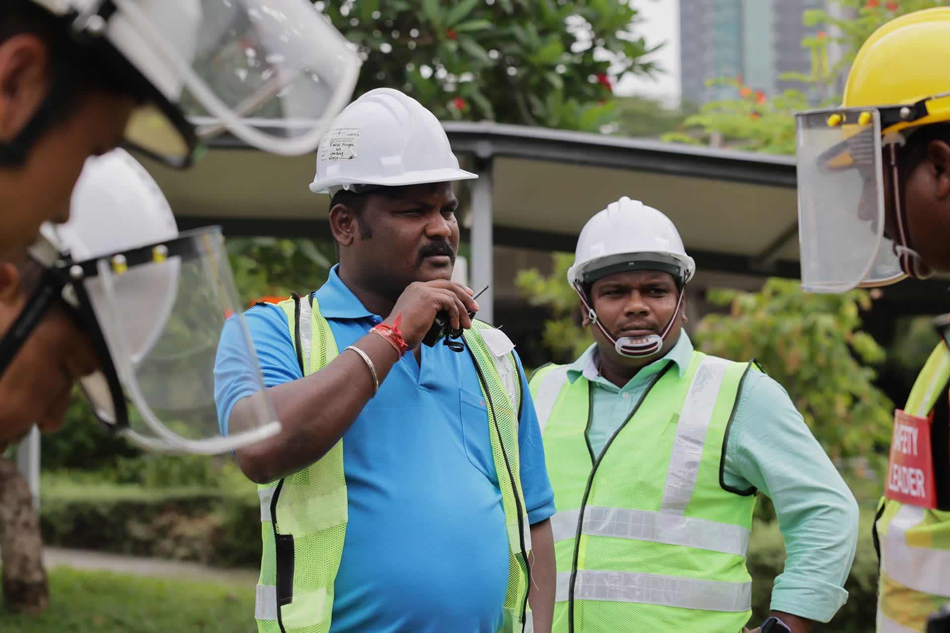PUB’s sewerage maintenance officers coordinate to signal that all is clear for the high-pressure water jet to be activated at Monk’s Hill Terrace manhole on May 24, 2024.