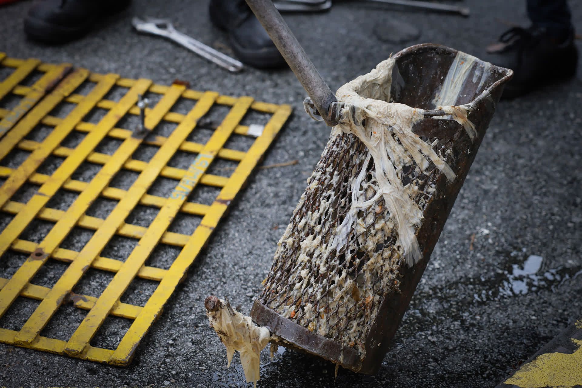 A grit catcher is used to capture the debris being washed down the sewer.
