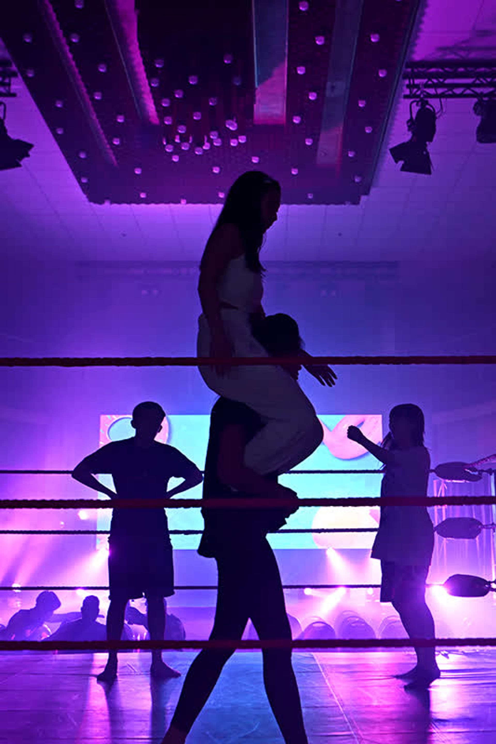 Lee carrying Japanese wrestler Riho during a warm-up session with the referee and Japanese wrestler Ancham (right, in background) before their hotly contested three-way Queen of Asia Championship match on Aug 18, 2023.