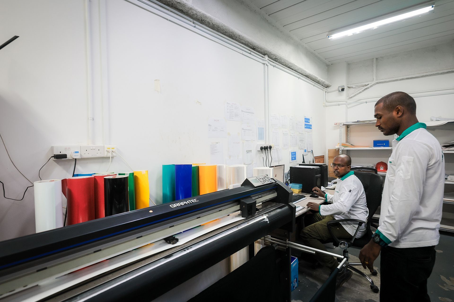 Letters and pictographs are cut using a computer-controlled vinyl cutting machine.