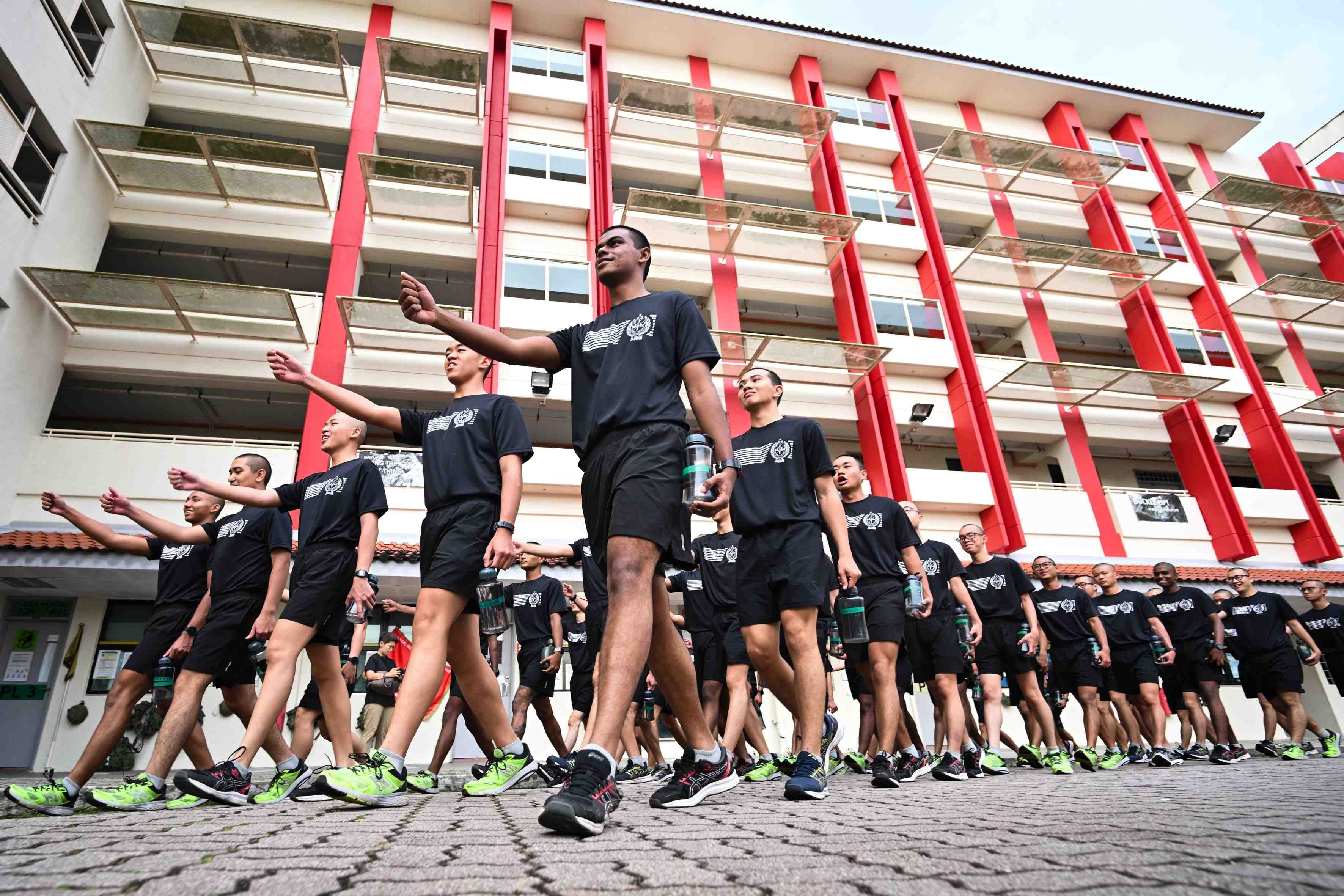 A group of men march in formation at the Basic Military Training Centre on Pulau Tekong.