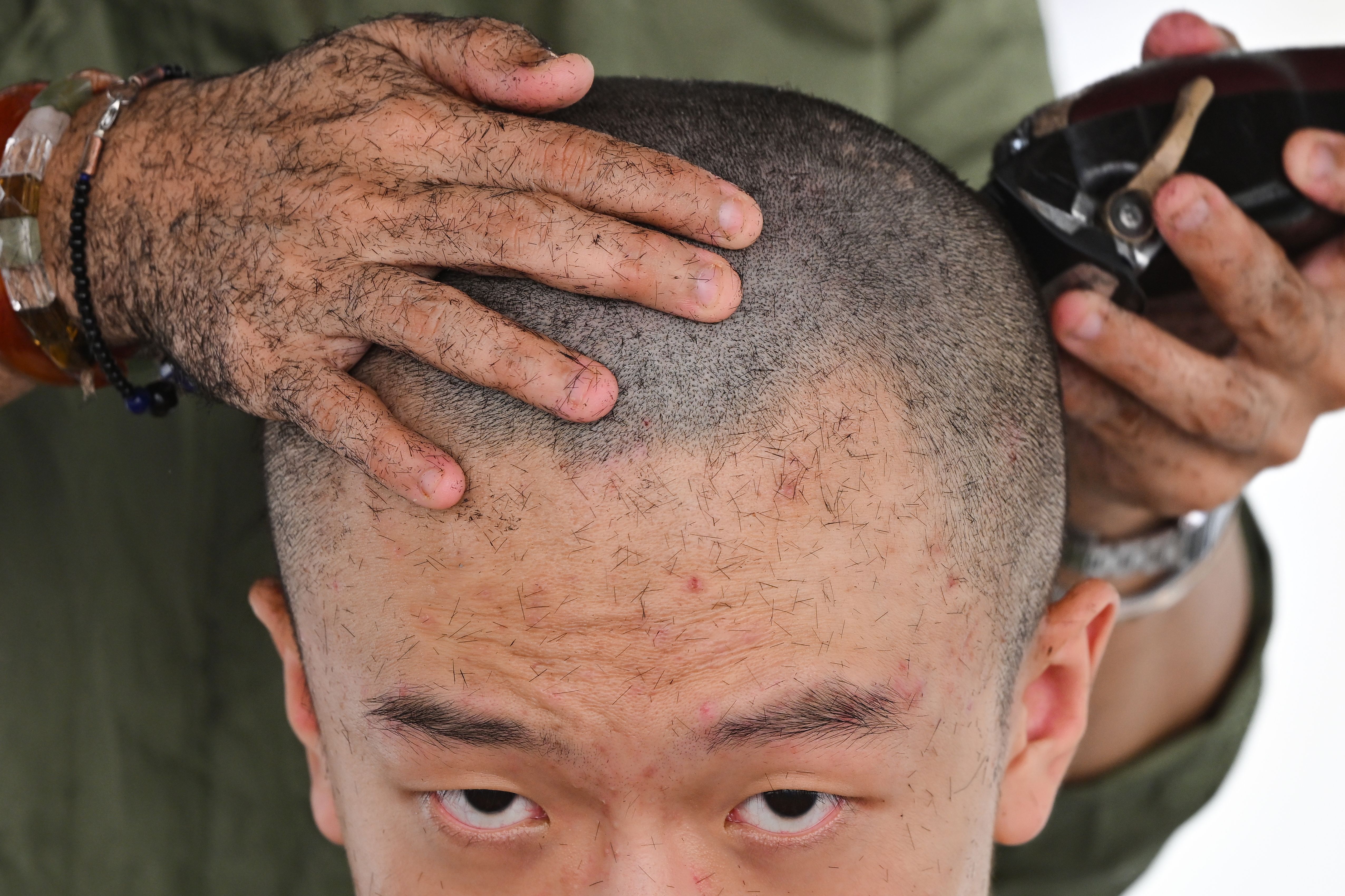 A man gets his head shaved