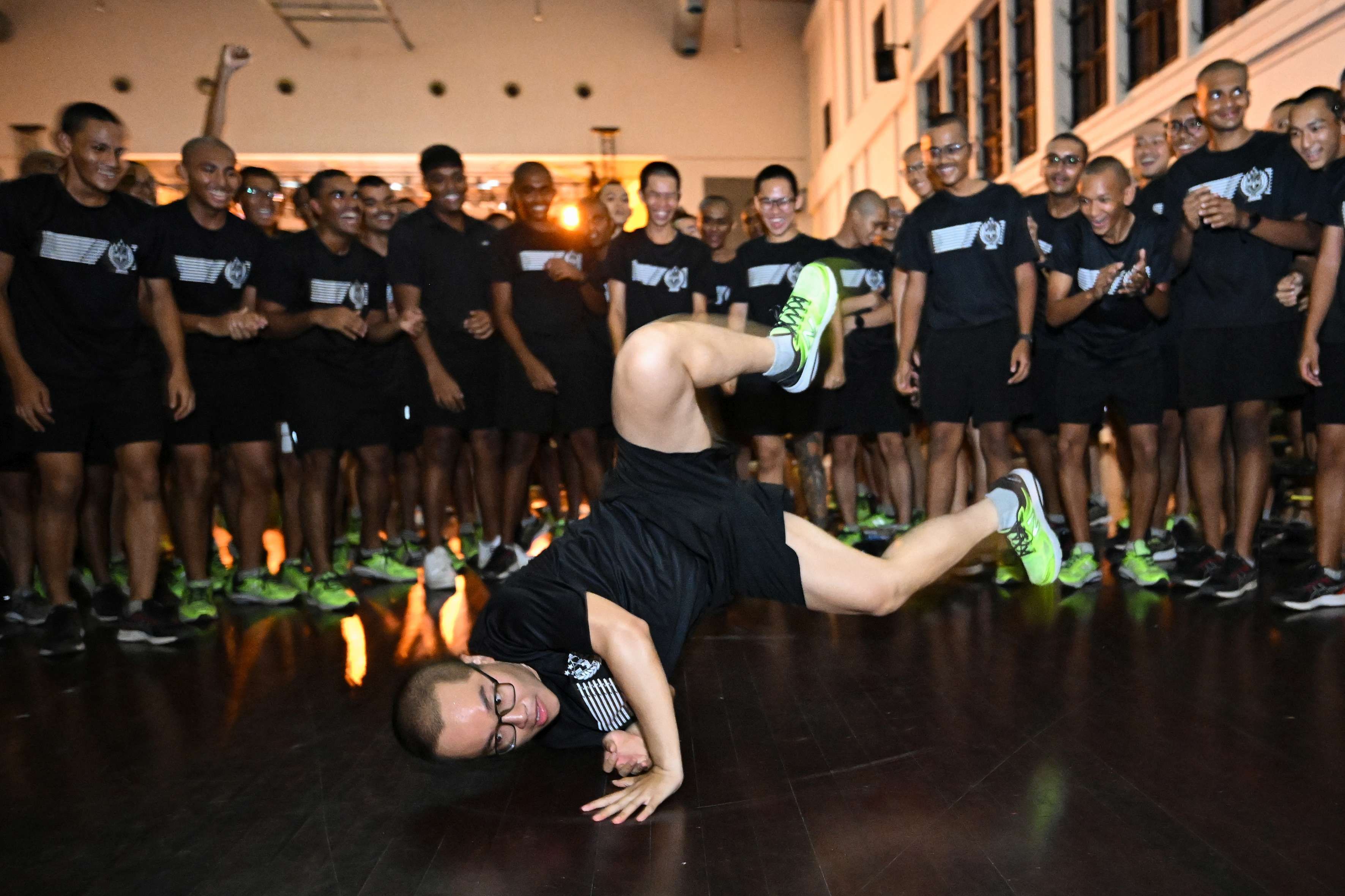 A man dances during a night function on Pulau Tekong