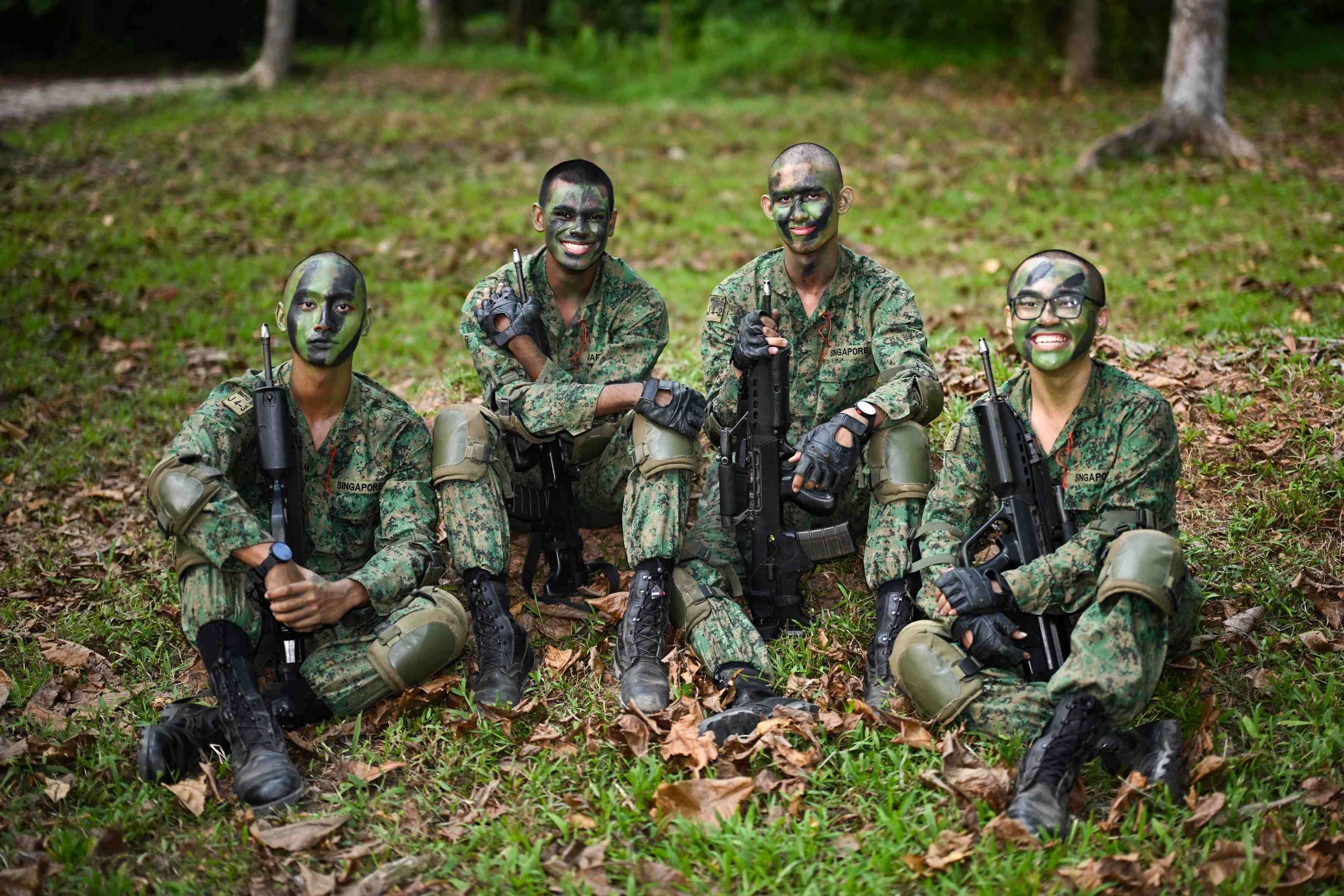 4 Men in the Singapore army uniform pictured next to each other on Pulau Tekong