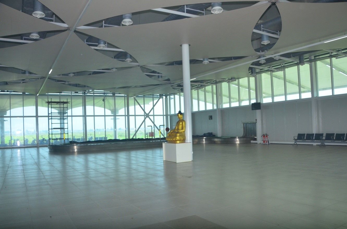 The empty exterior of Kushinagar International airport, with a Buddhist statue.
