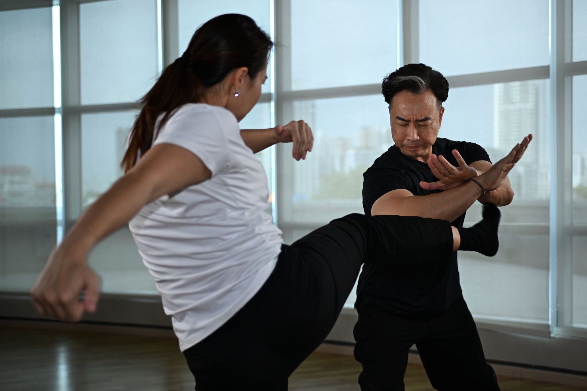 Tjen practising defence tactics and unarmed combat with his colleague Ng.