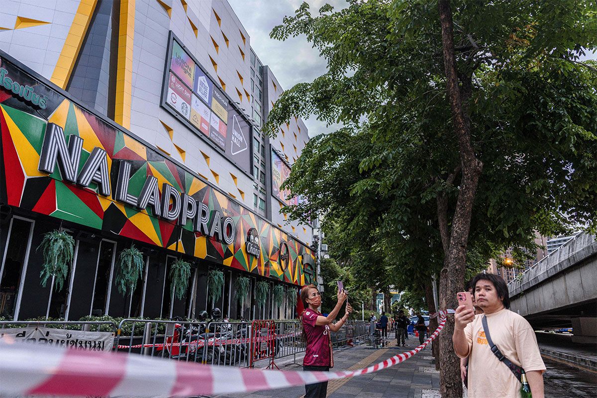 People outside the Rong Beer Na Lat Phrao bar after a fire in Bangkok on July 13, 2026.