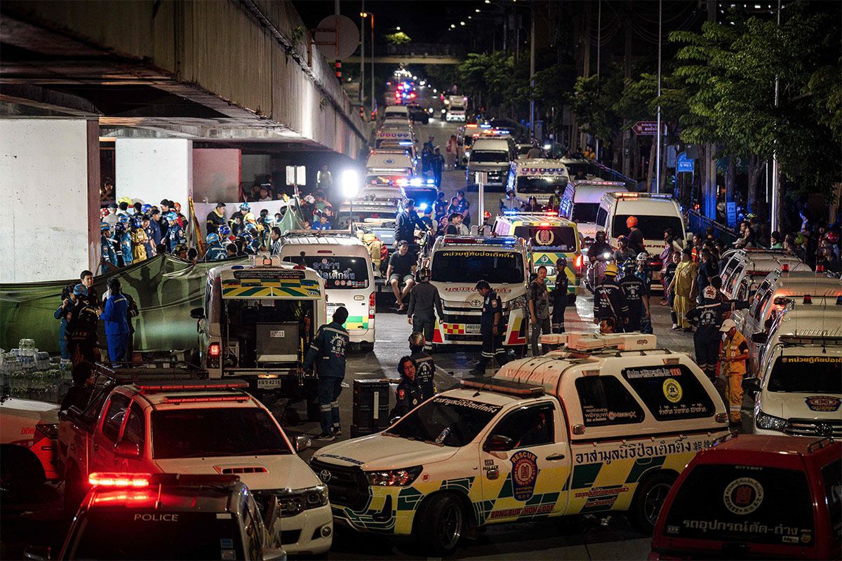 An ambulance is parked outside a bar after a massive fire broke out in Bangkok, early on July 13, 2026.