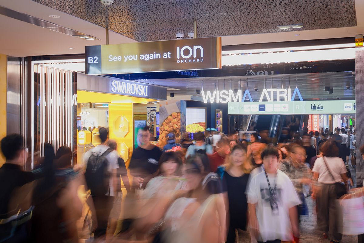 Shoppers walk between Ion Orchard and Wisma Atria on Orchard Road on July 11, 2026.