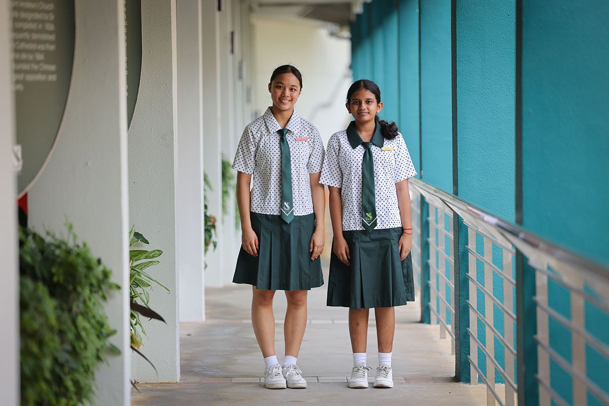 Students Jazzlynn Ng (left) and Triya Namo in the St Margaret’s School (Secondary) uniform with a matching tie. As a student councillor, Triya is distinguished by the green collar of her outfit. ST PHOTO: ONG WEE JIN
